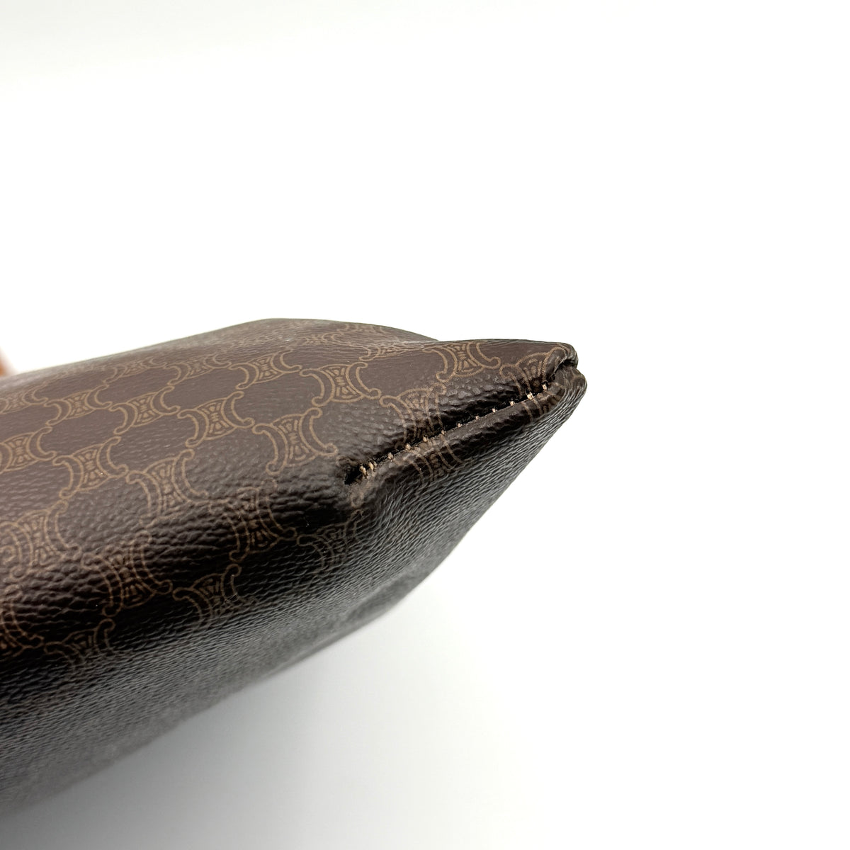 Front view of the Celine Triomphe Macadam Tote Bag in brown coated canvas with tan leather detailing and double handles.