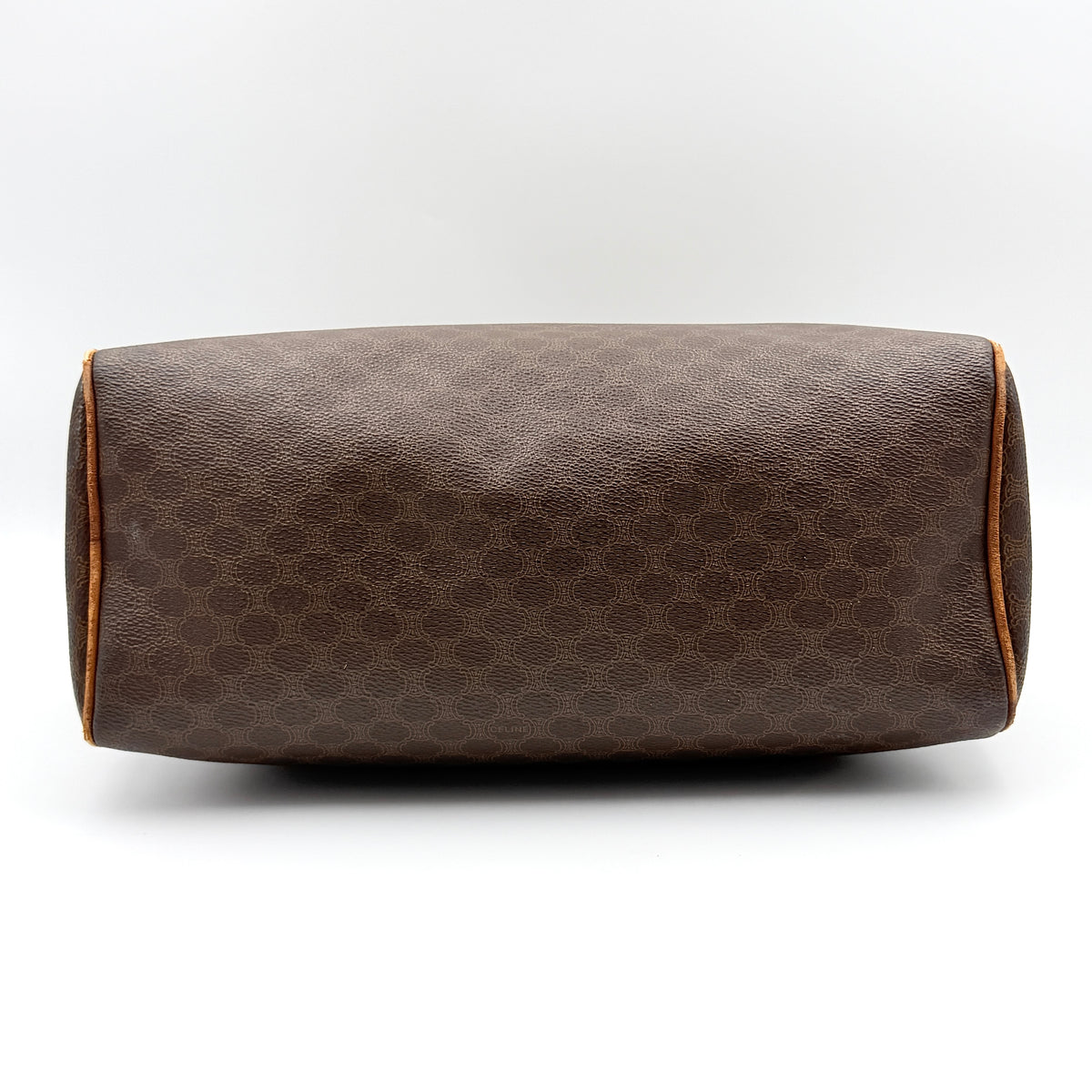 Celine Triomphe Macadam Boston Bag in brown coated canvas with tan leather trim and top handles, photographed against a white background.