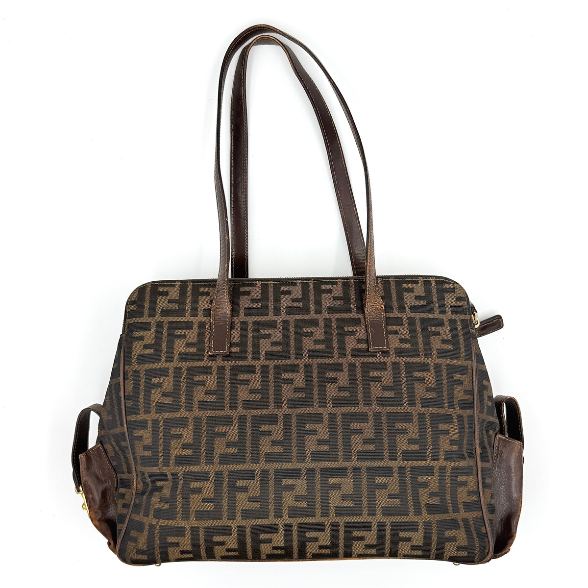 Fendi FF Zucca Double Zip Tote Bag in brown monogram canvas with leather straps and side pocket detail, shown on a yellow dust bag.