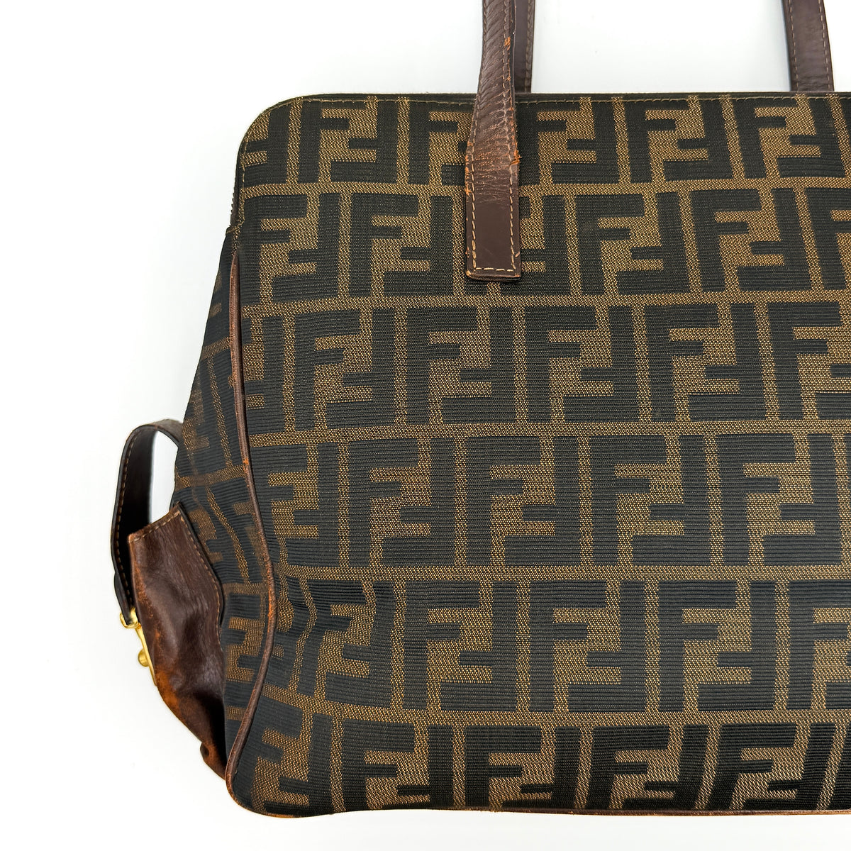 Fendi FF Zucca Double Zip Tote Bag in brown monogram canvas with leather straps and side pocket detail, shown on a yellow dust bag.
