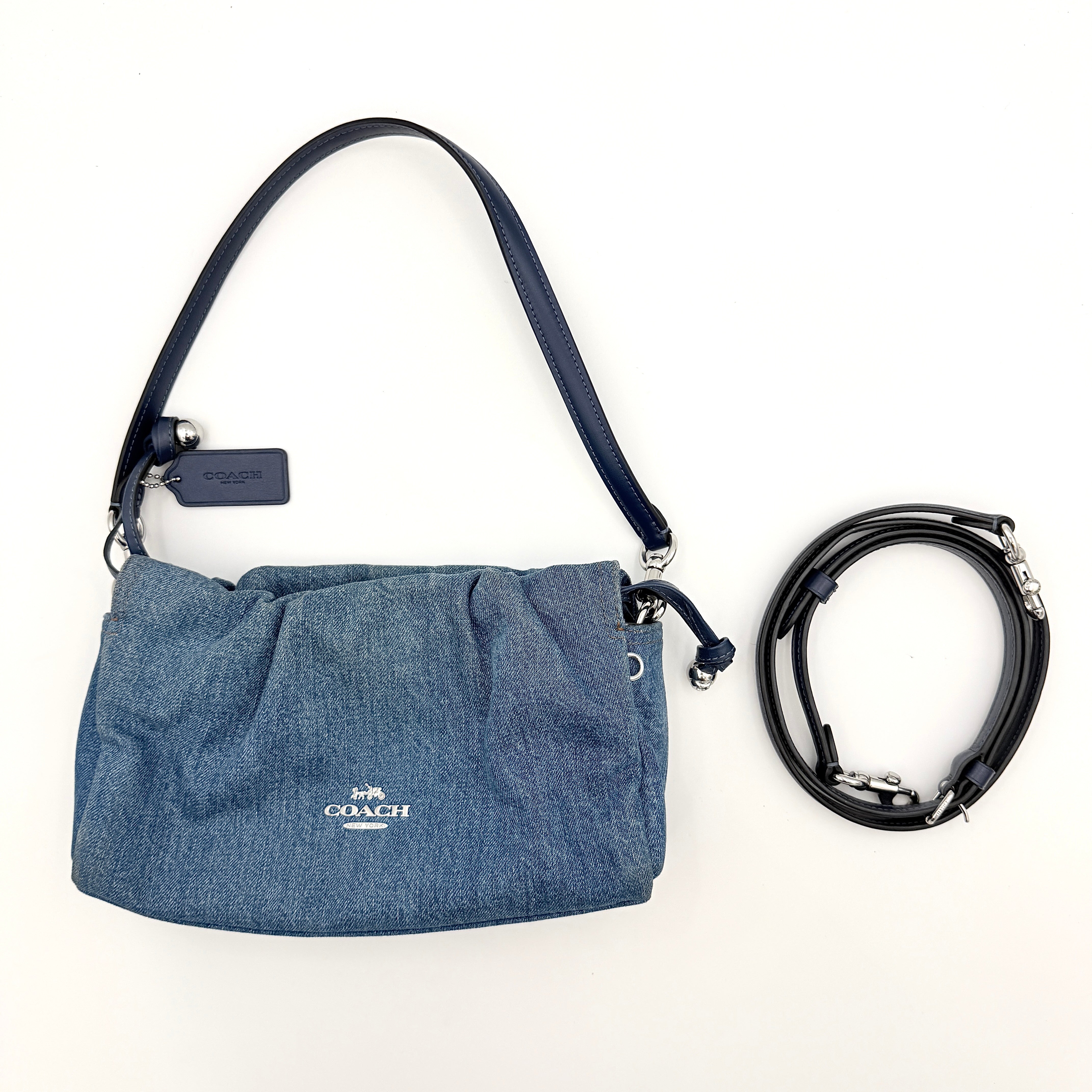 Coach Faye Shoulder Bag in blue denim with navy leather strap and detachable crossbody, styled simply against a white background.