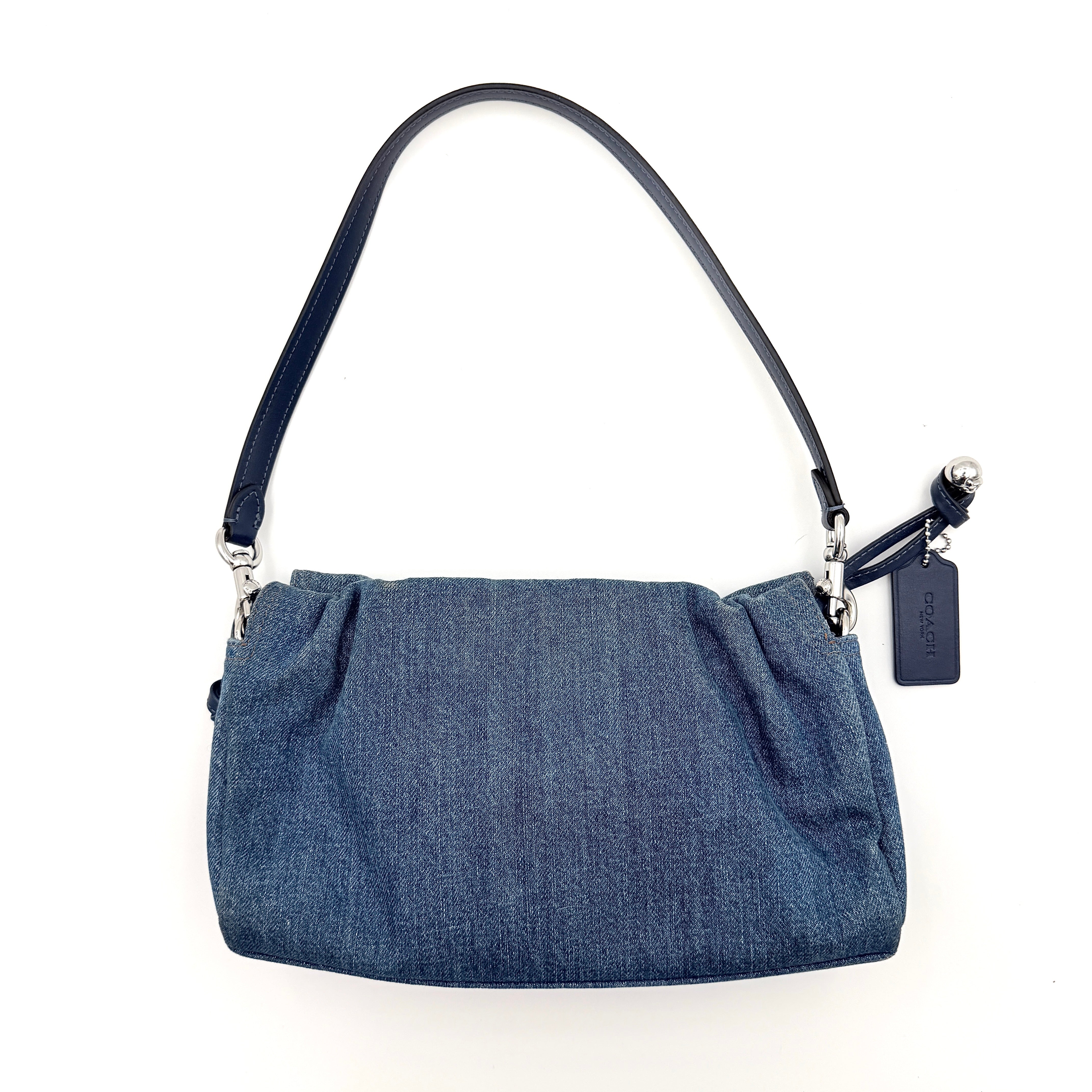 Coach Faye Shoulder Bag in blue denim with navy leather strap and detachable crossbody, styled simply against a white background.