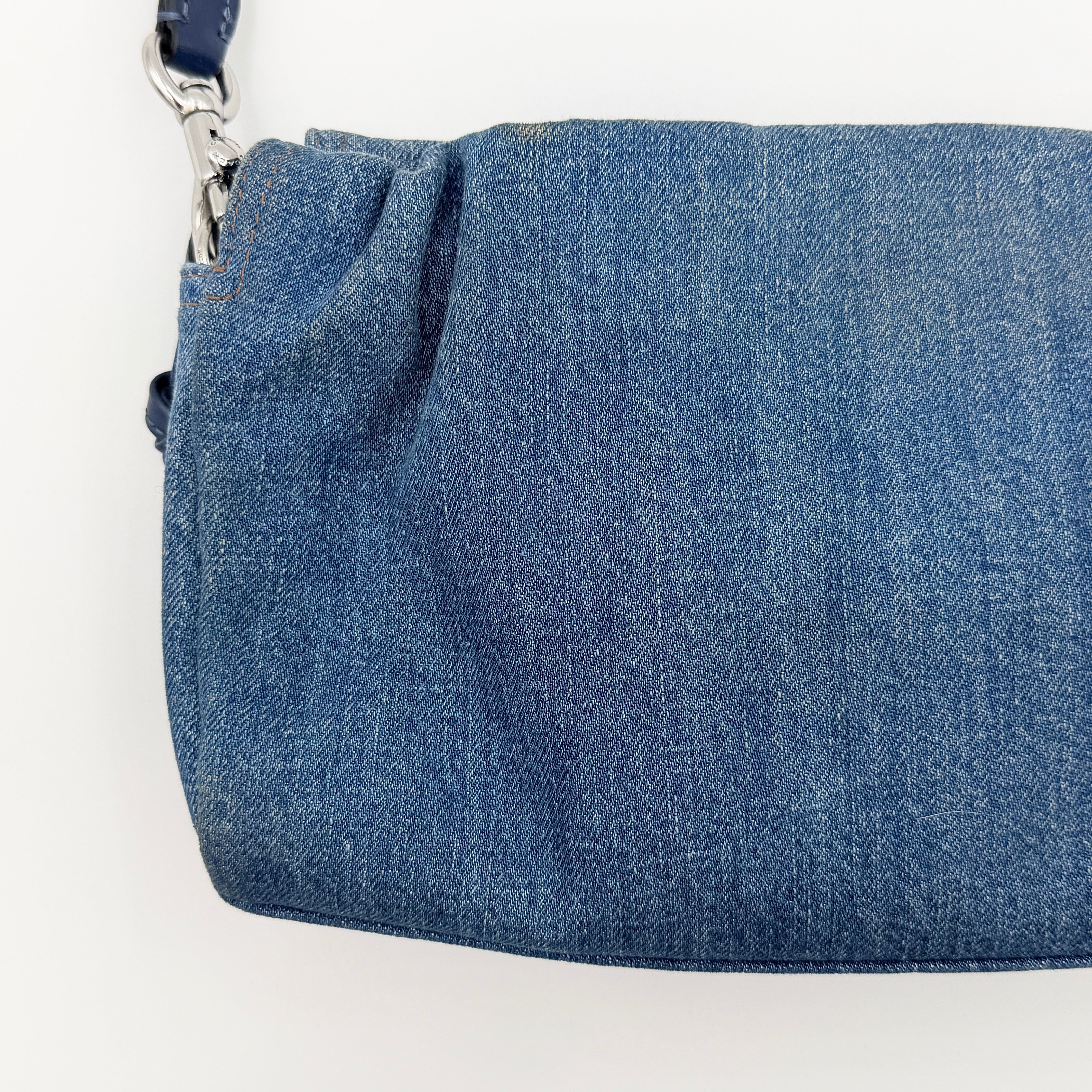 Coach Faye Shoulder Bag in blue denim with navy leather strap and detachable crossbody, styled simply against a white background.