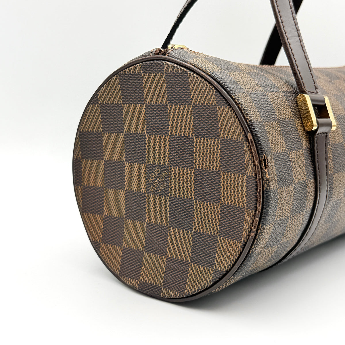 Louis Vuitton Damier Ebene Papillon 26 handbag in brown checked canvas with chocolate leather handles and gold hardware against a white background.