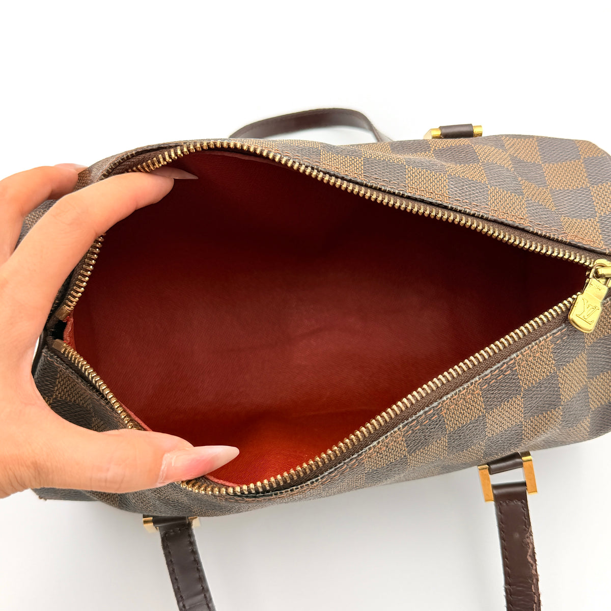 Louis Vuitton Damier Ebene Papillon 26 handbag in brown checked canvas with chocolate leather handles and gold hardware against a white background.