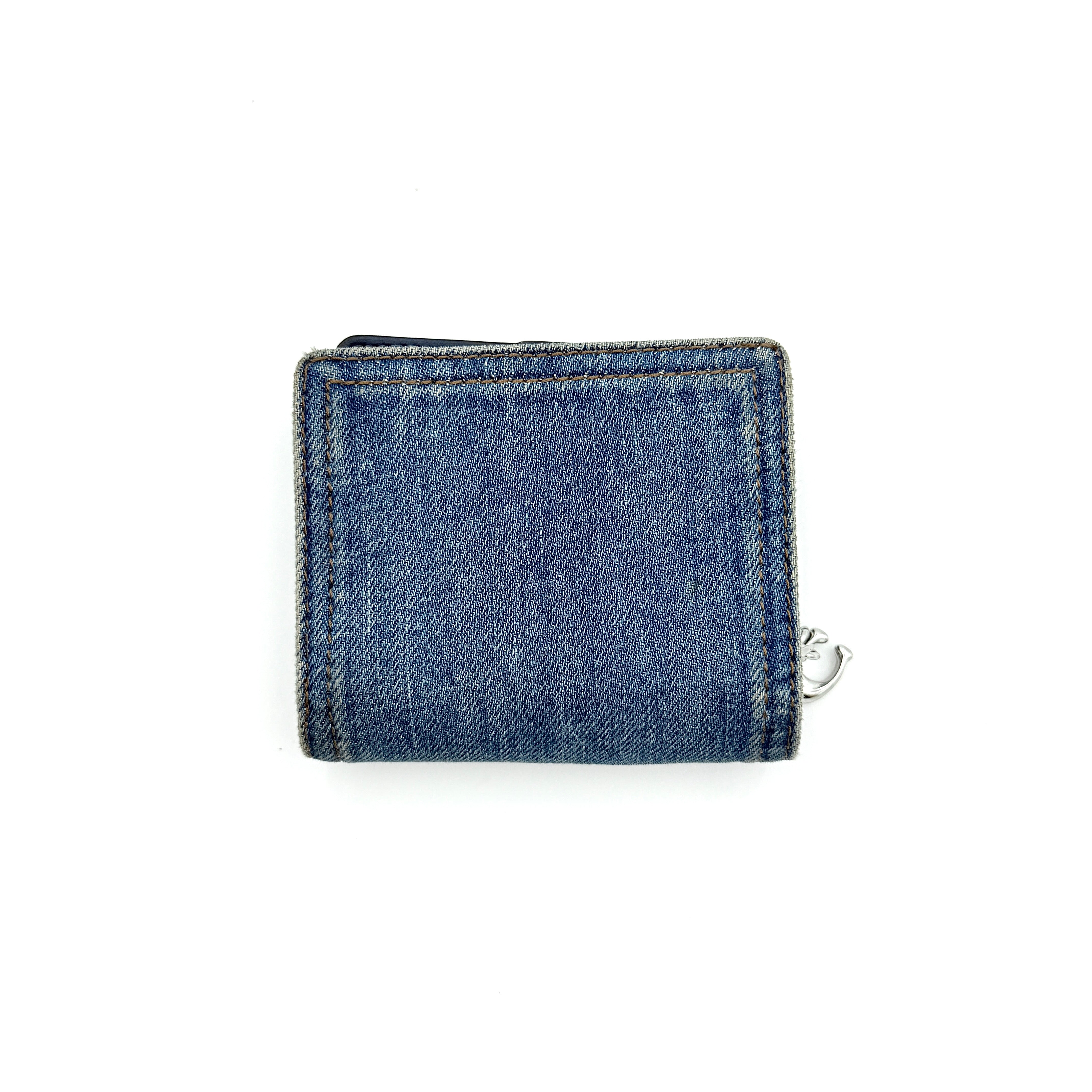 Coach Signature Snap Wallet in blue denim with silver-tone logo, shown closed from the front.