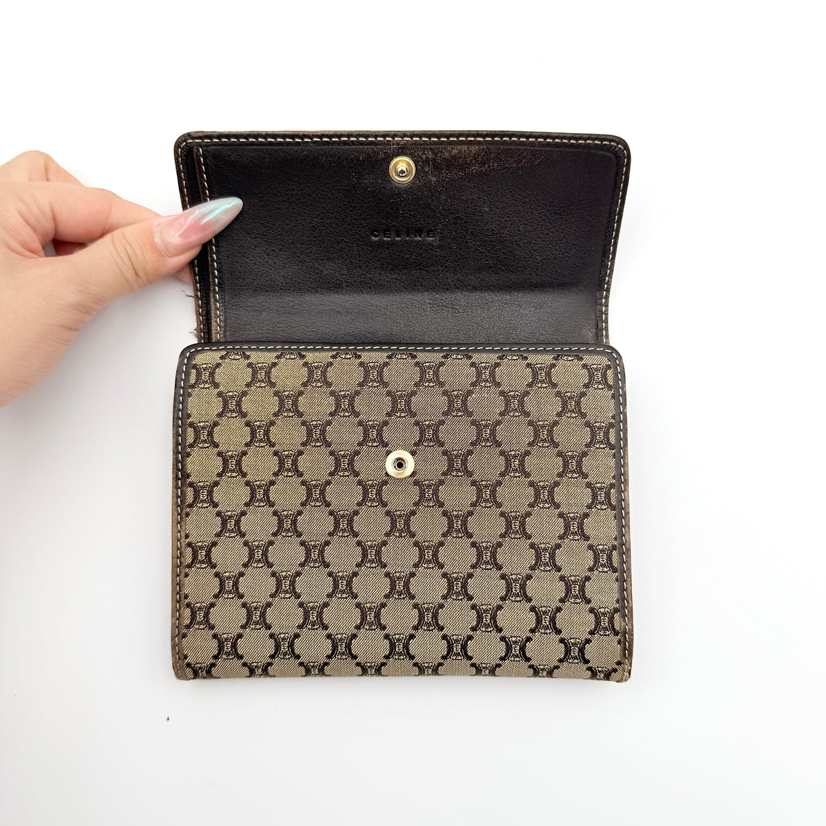 Celine Macadam Monogram Trifold Wallet in brown coated canvas with all-over motif, photographed closed on a white background