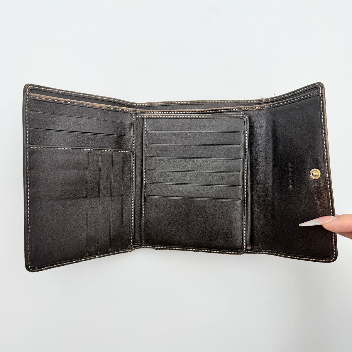 Celine Macadam Monogram Trifold Wallet in brown coated canvas with all-over motif, photographed closed on a white background