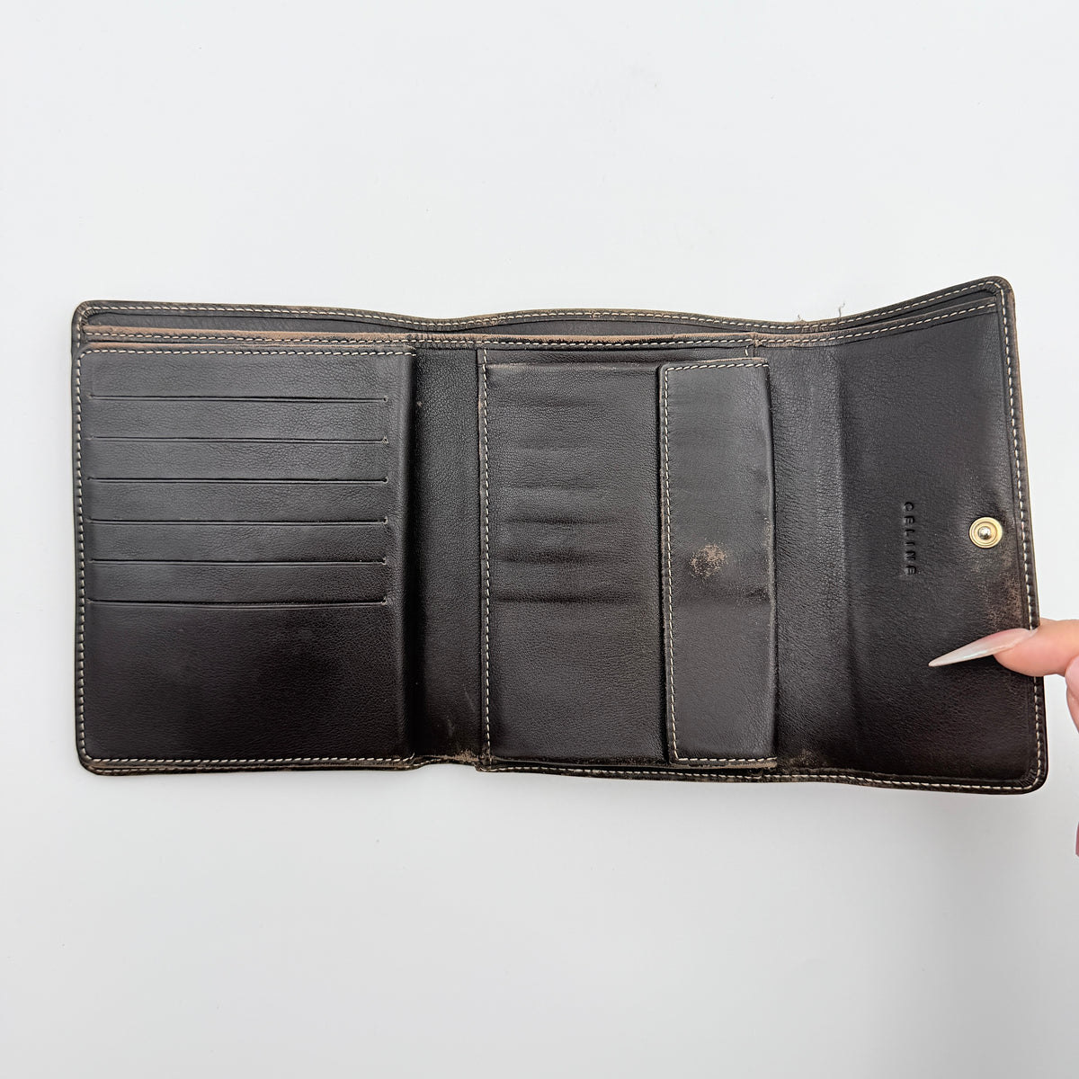 Celine Macadam Monogram Trifold Wallet in brown coated canvas with all-over motif, photographed closed on a white background
