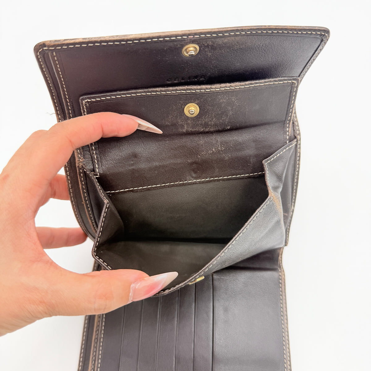 Celine Macadam Monogram Trifold Wallet in brown coated canvas with all-over motif, photographed closed on a white background