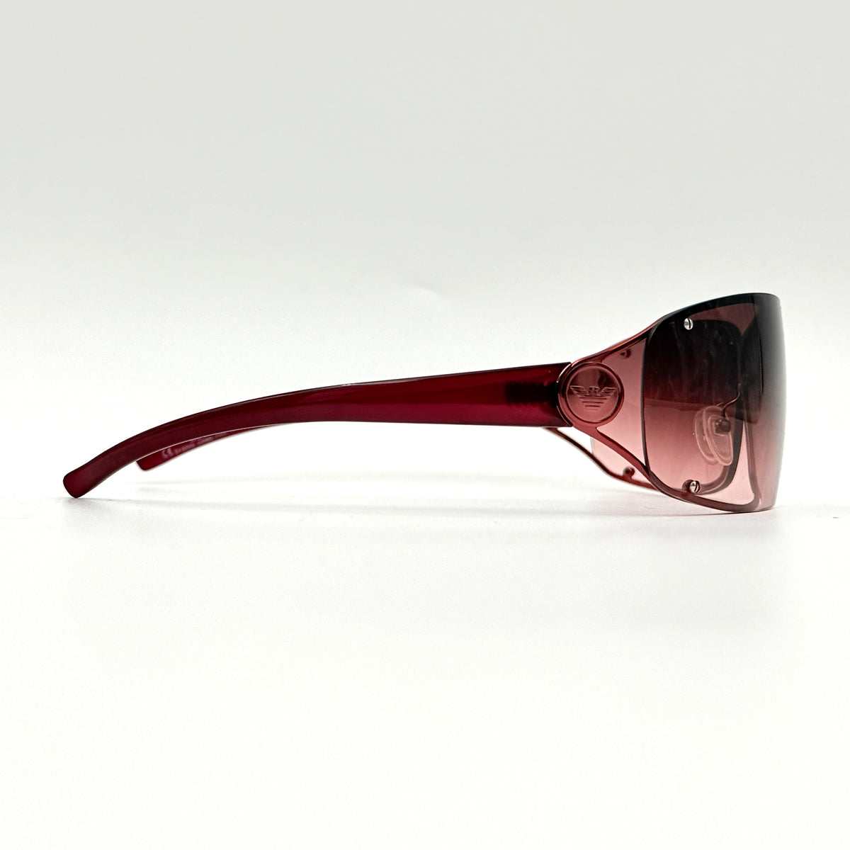 Emporio Armani EA 9251/S sunglasses in translucent red with gradient lenses and silver-tone logo detail at the temple.
