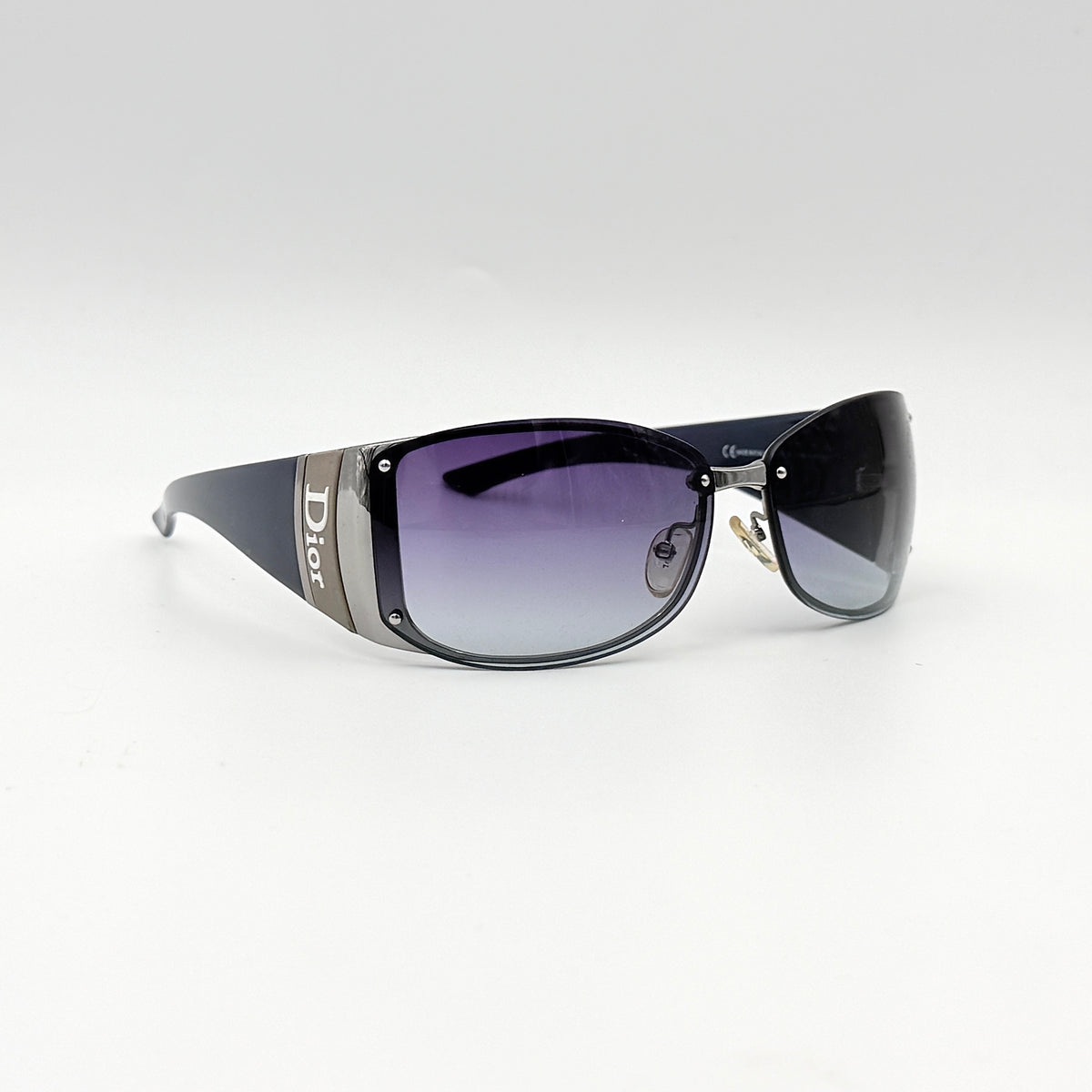 Christian Dior SUBDIOR 1/F sunglasses in navy blue with wide arms, gradient lenses, and silver-tone logo detail at the temples.
