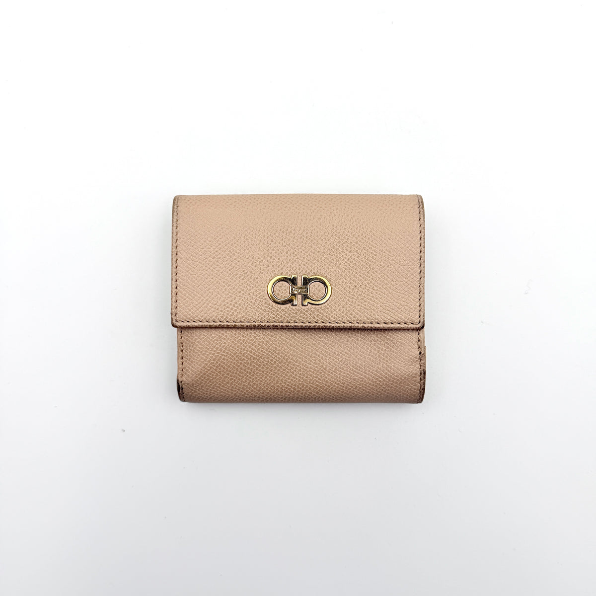 Salvatore Ferragamo beige grained leather compact bifold wallet with gold Gancini hardware, photographed on a white background.