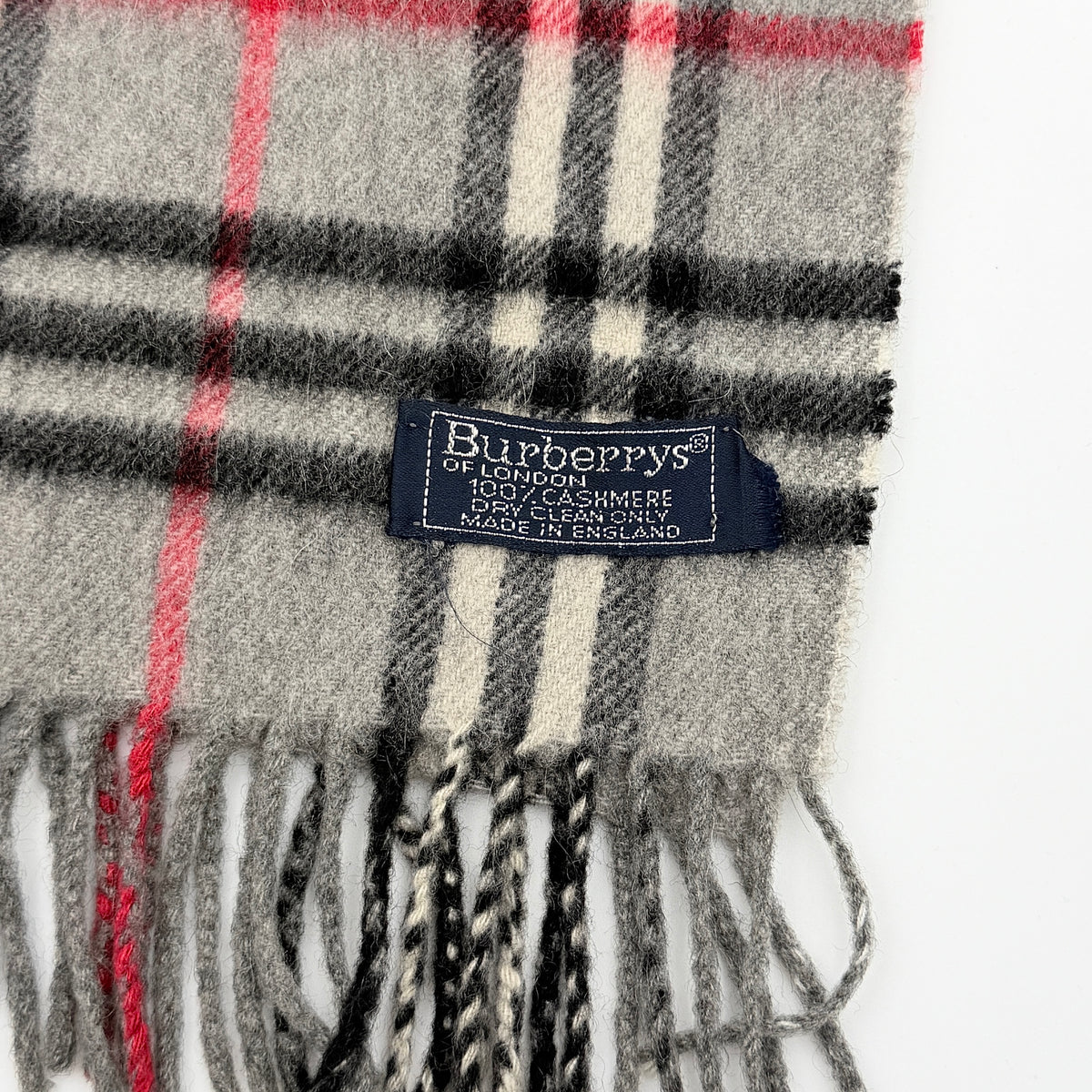 Burberry grey cashmere scarf with Nova Check pattern and classic fringe, featuring a Burberrys of London label.