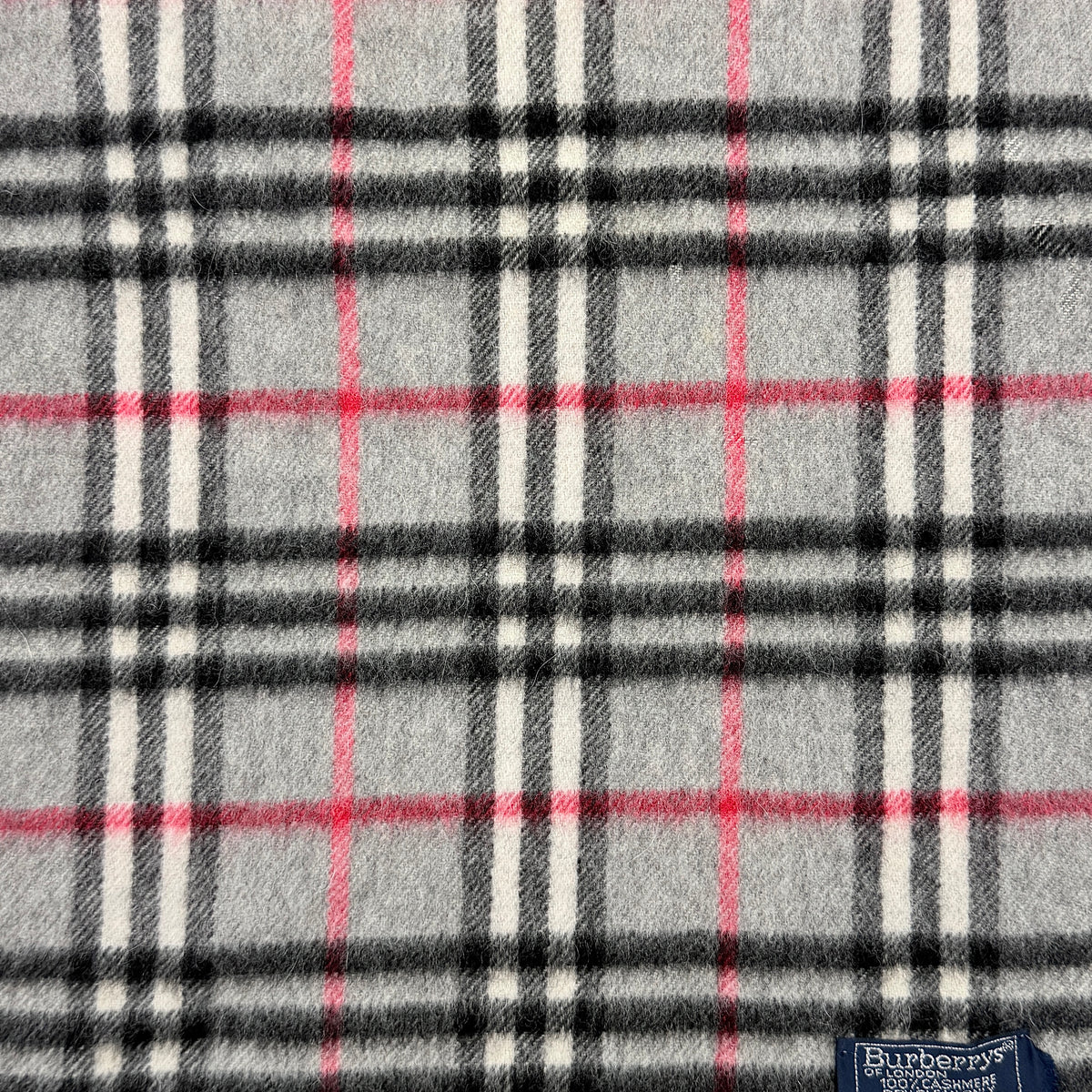 Burberry grey cashmere scarf with Nova Check pattern and classic fringe, featuring a Burberrys of London label.