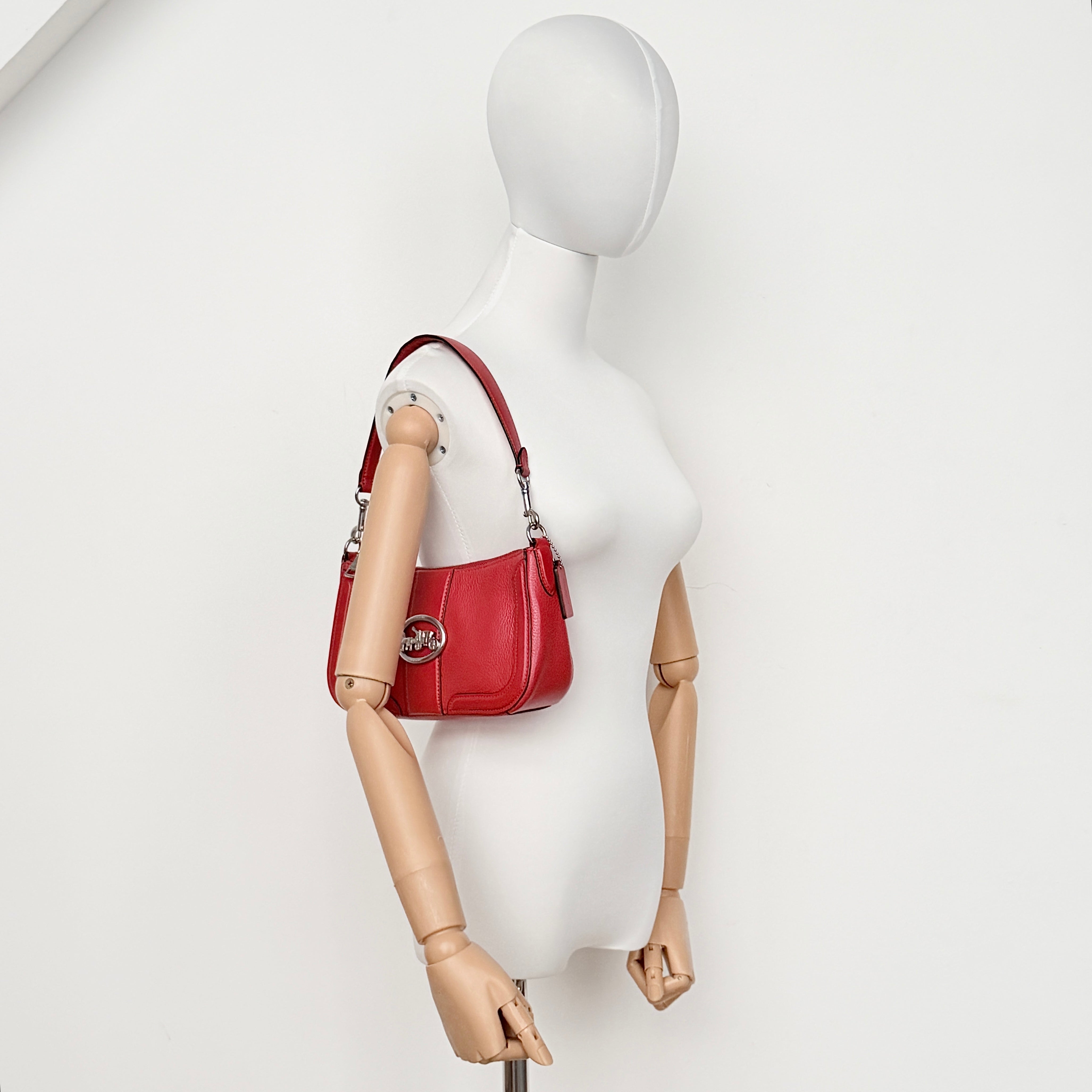 Coach 2Way Georgie Baguette in red pebbled leather with silver carriage logo hardware, shown with removable shoulder strap.