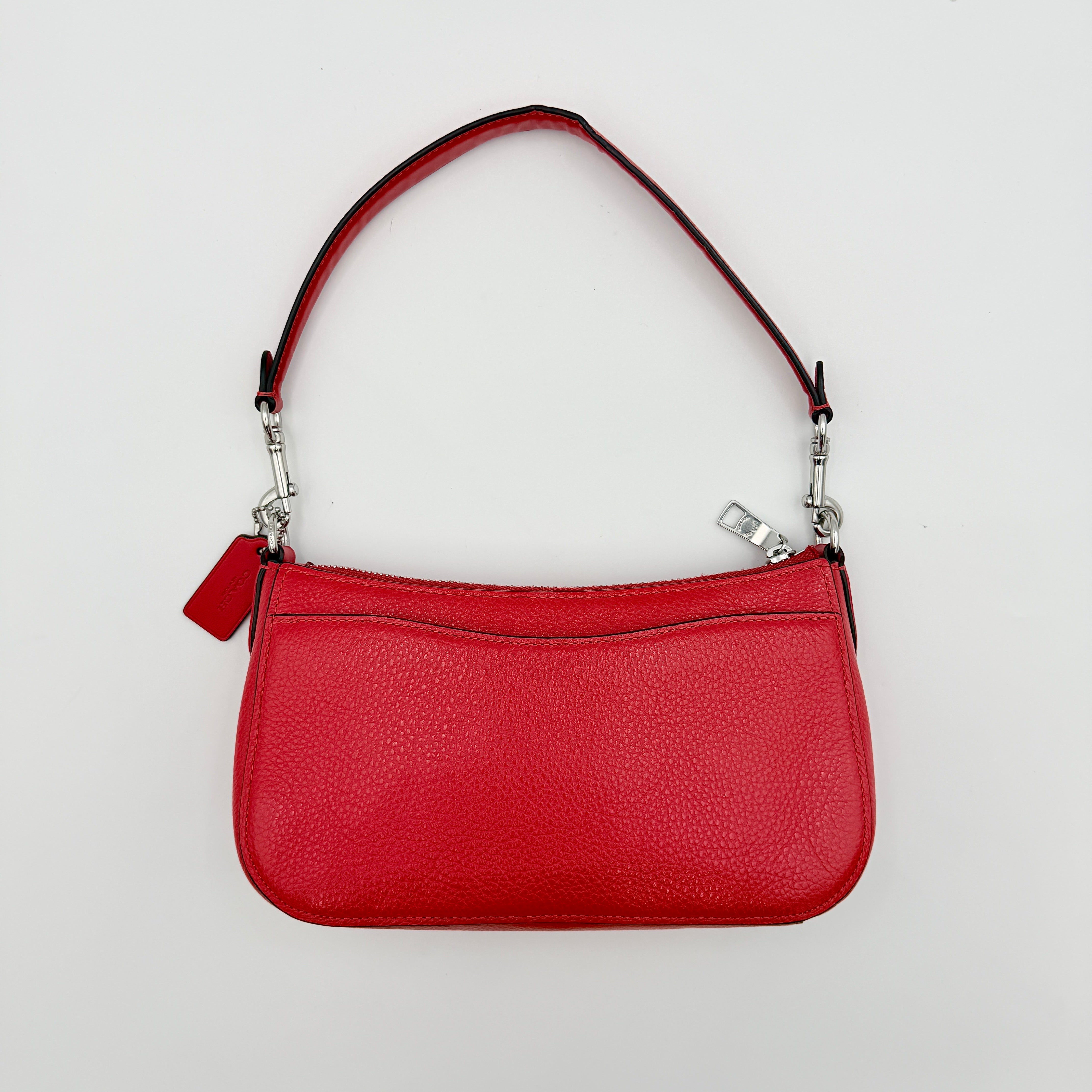 Coach 2Way Georgie Baguette in red pebbled leather with silver carriage logo hardware, shown with removable shoulder strap.