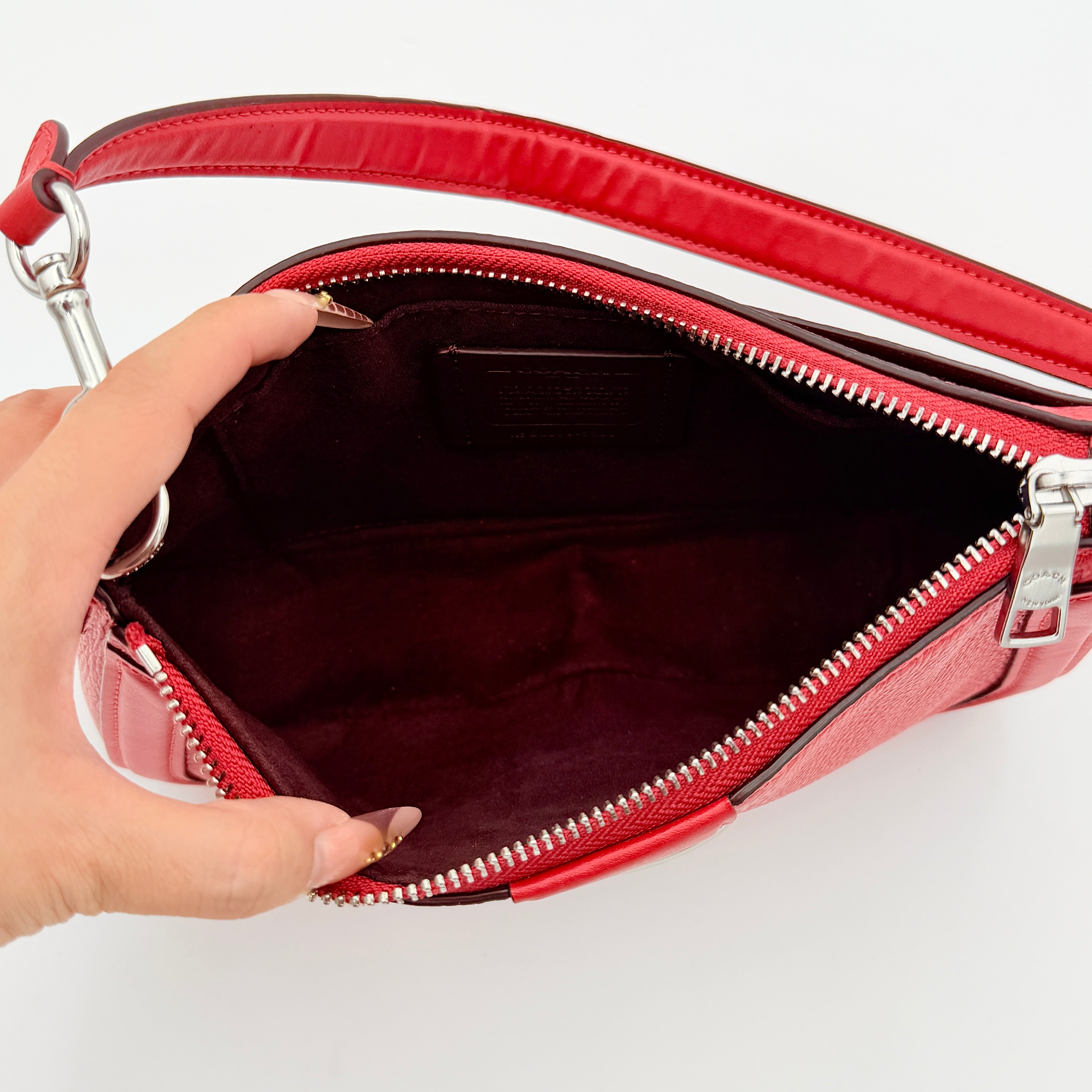 Coach 2Way Georgie Baguette in red pebbled leather with silver carriage logo hardware, shown with removable shoulder strap.