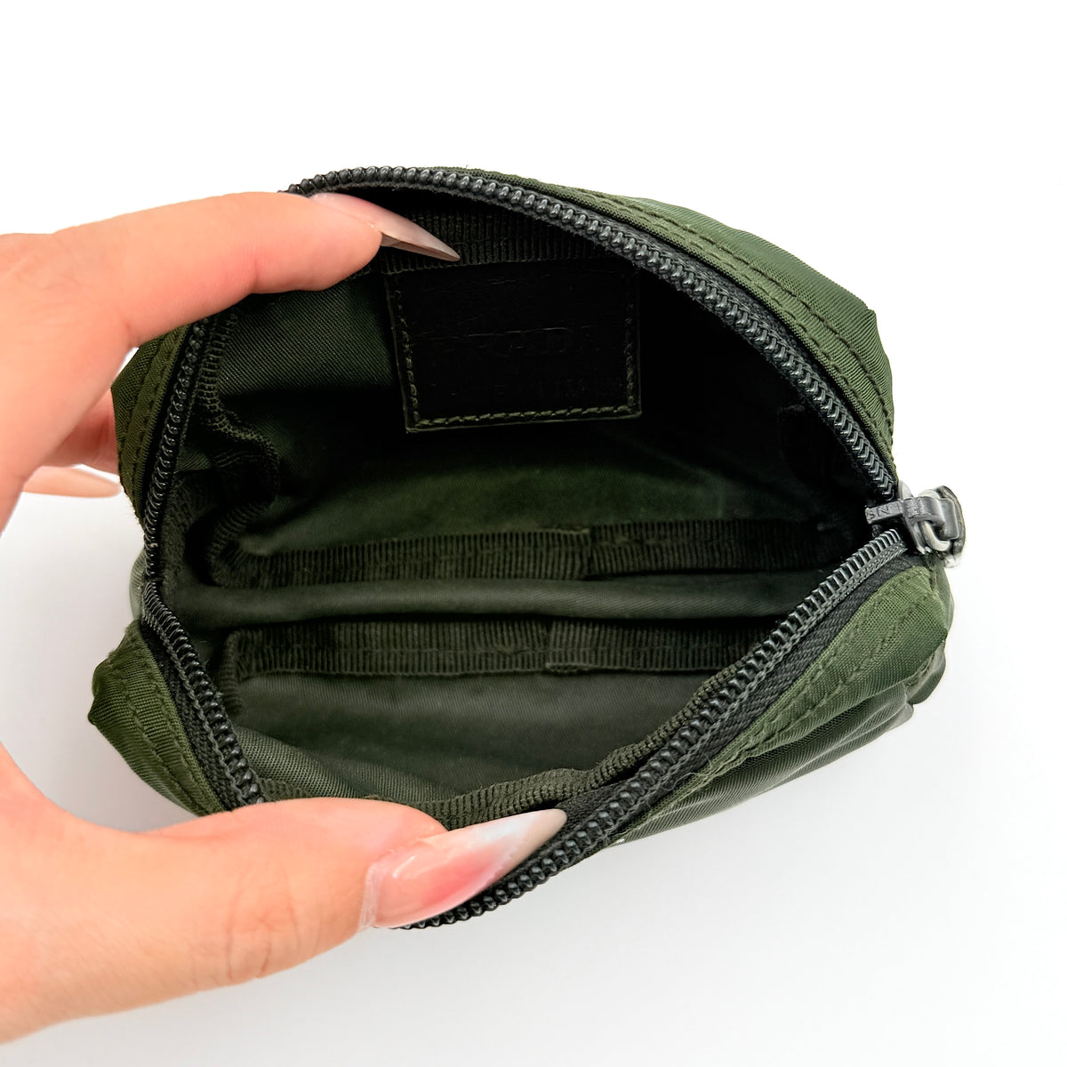 Prada Nylon Utility Pouch in dark green with silver triangle logo and zip closure.