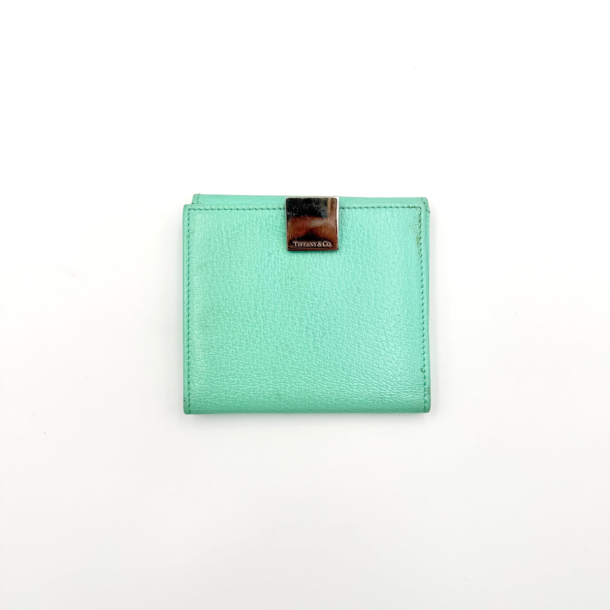 Tiffany & Co. bifold compact wallet in Tiffany Blue leather with silver-tone clasp, photographed on a clean white background.