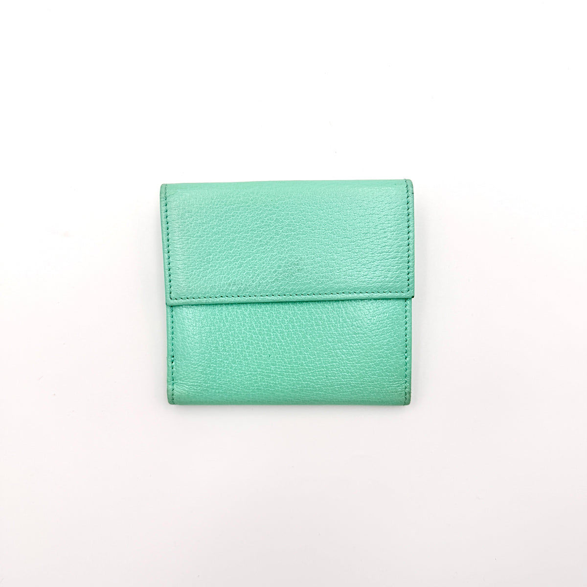 Tiffany & Co. bifold compact wallet in Tiffany Blue leather with silver-tone clasp, photographed on a clean white background.