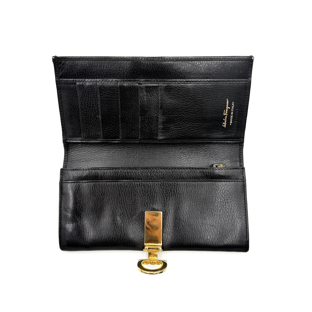 Salvatore Ferragamo Gancini Continental Wallet in black leather with gold-tone Gancini clasp, photographed closed on a white background.