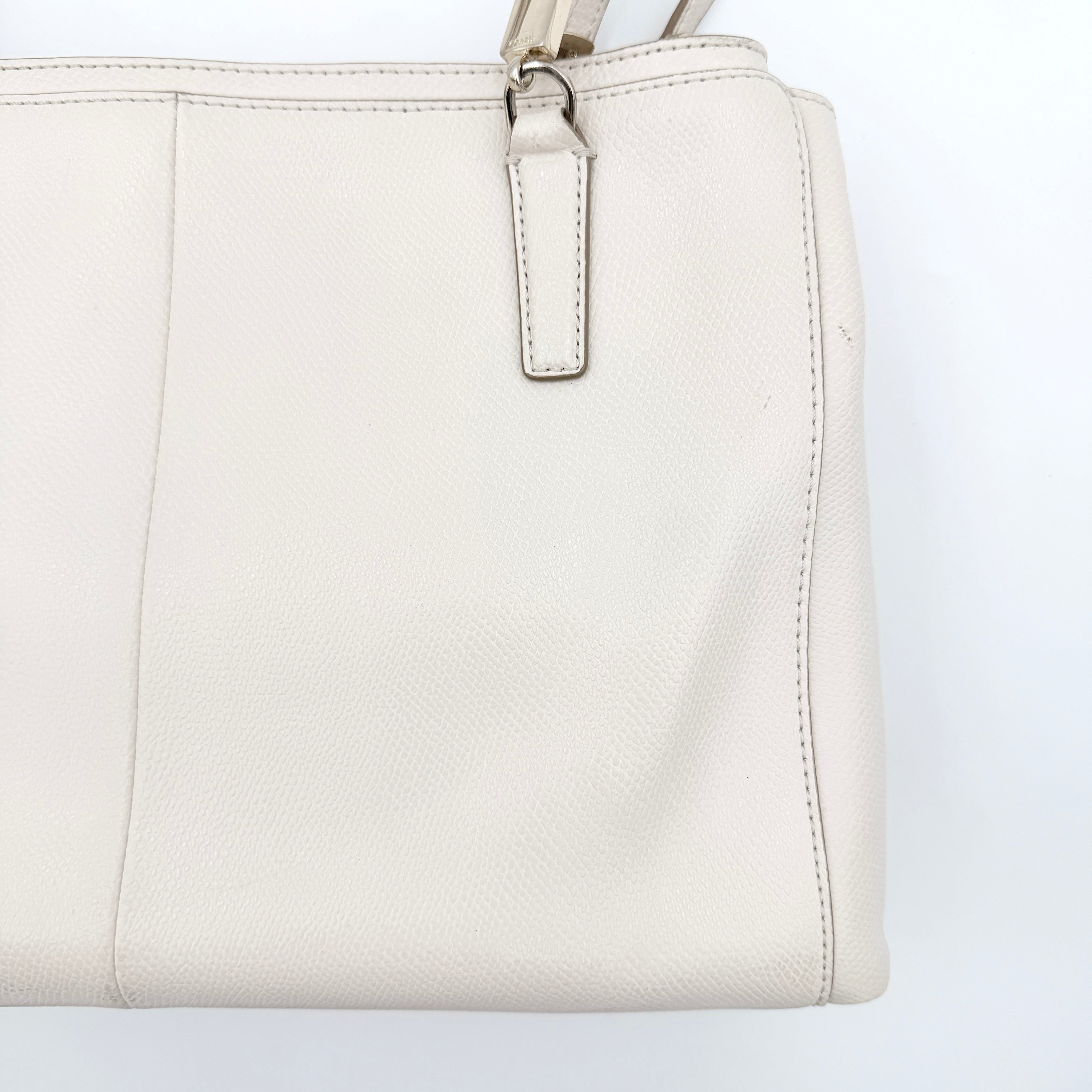 Coach Parker 16 shoulder bag in white leather with dual top handles and gold-tone accents, displayed against a clean background.