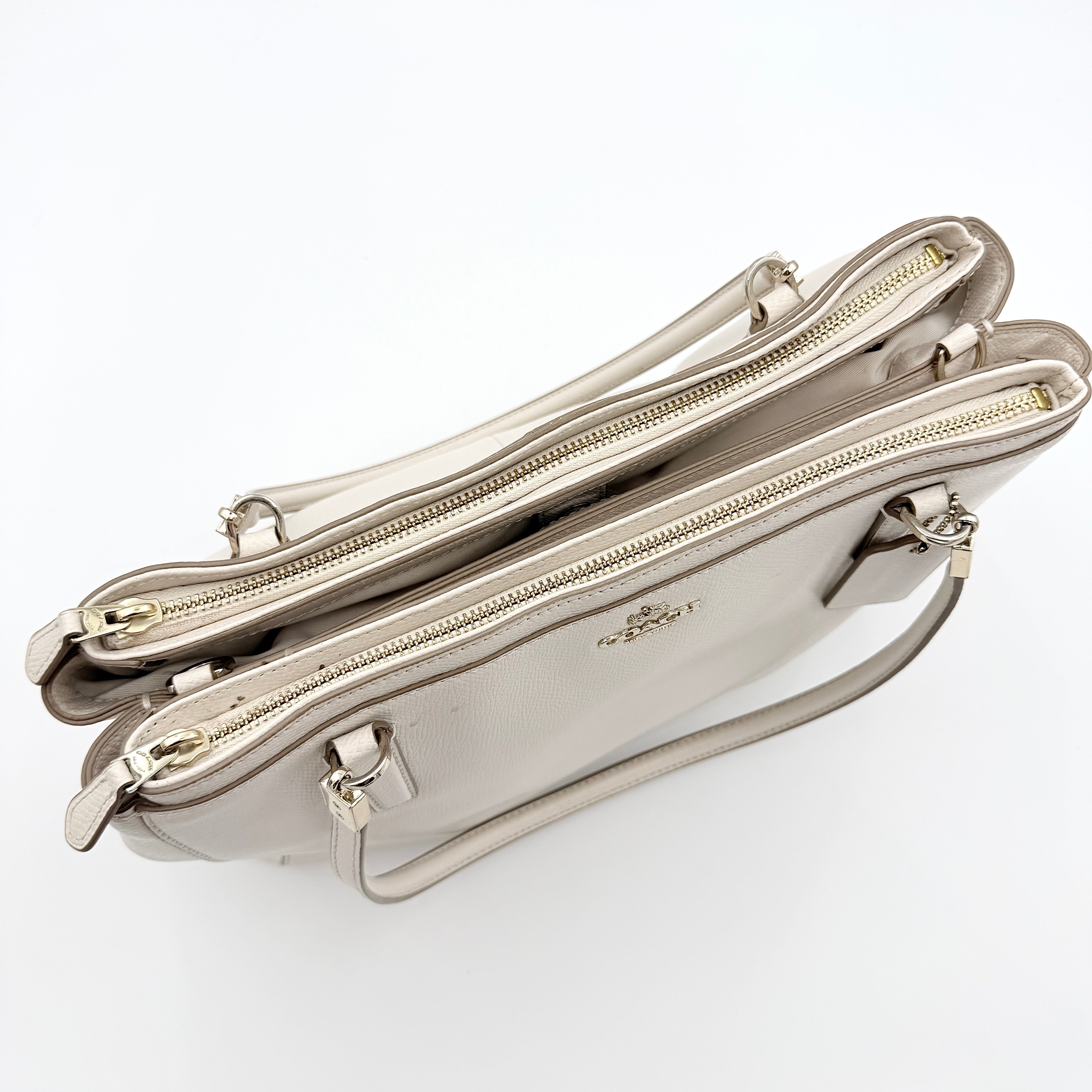 Coach Parker 16 shoulder bag in white leather with dual top handles and gold-tone accents, displayed against a clean background.