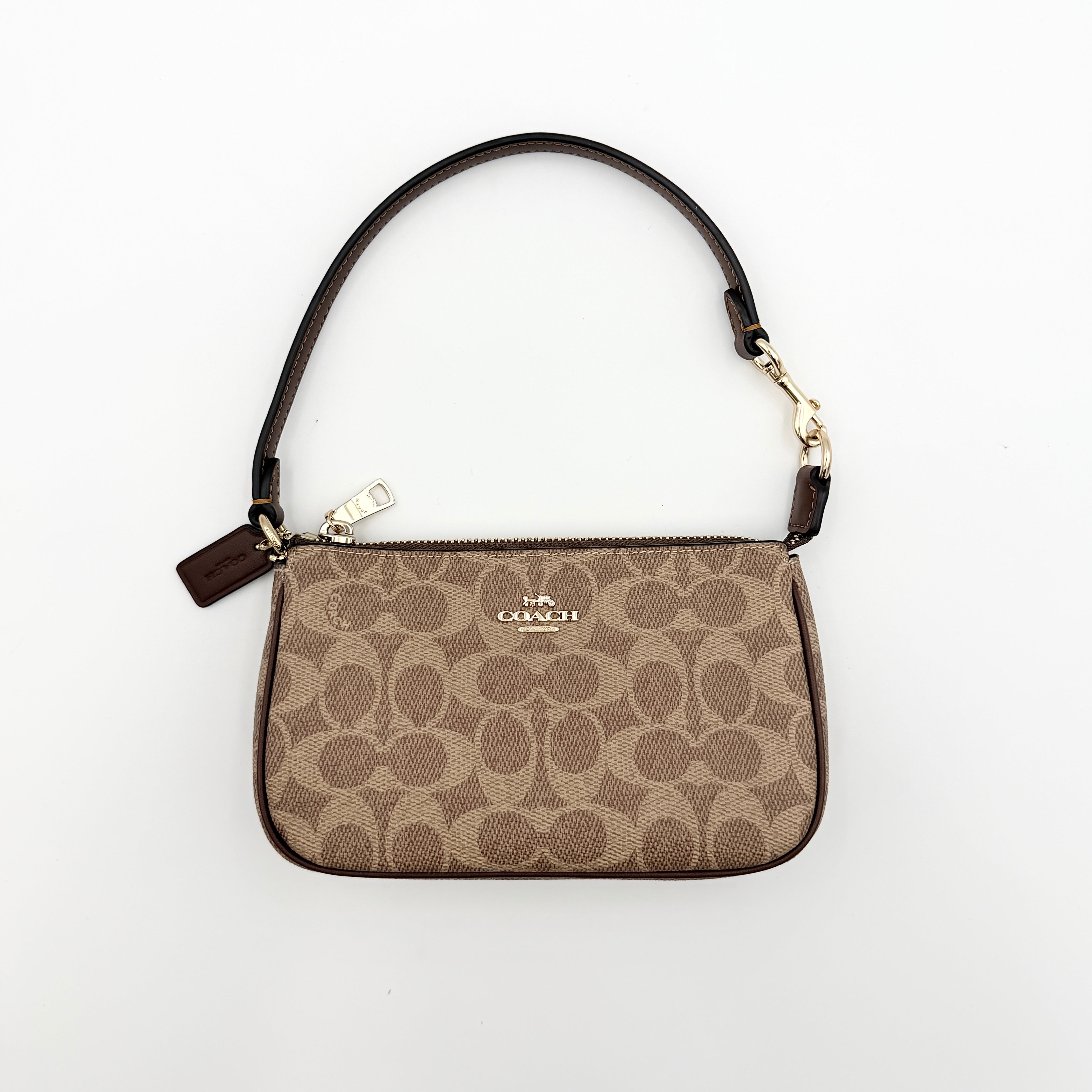 Coach Signature Nolita 19 Shoulder Bag in beige and brown canvas with gold tone hardware and detachable leather strap.