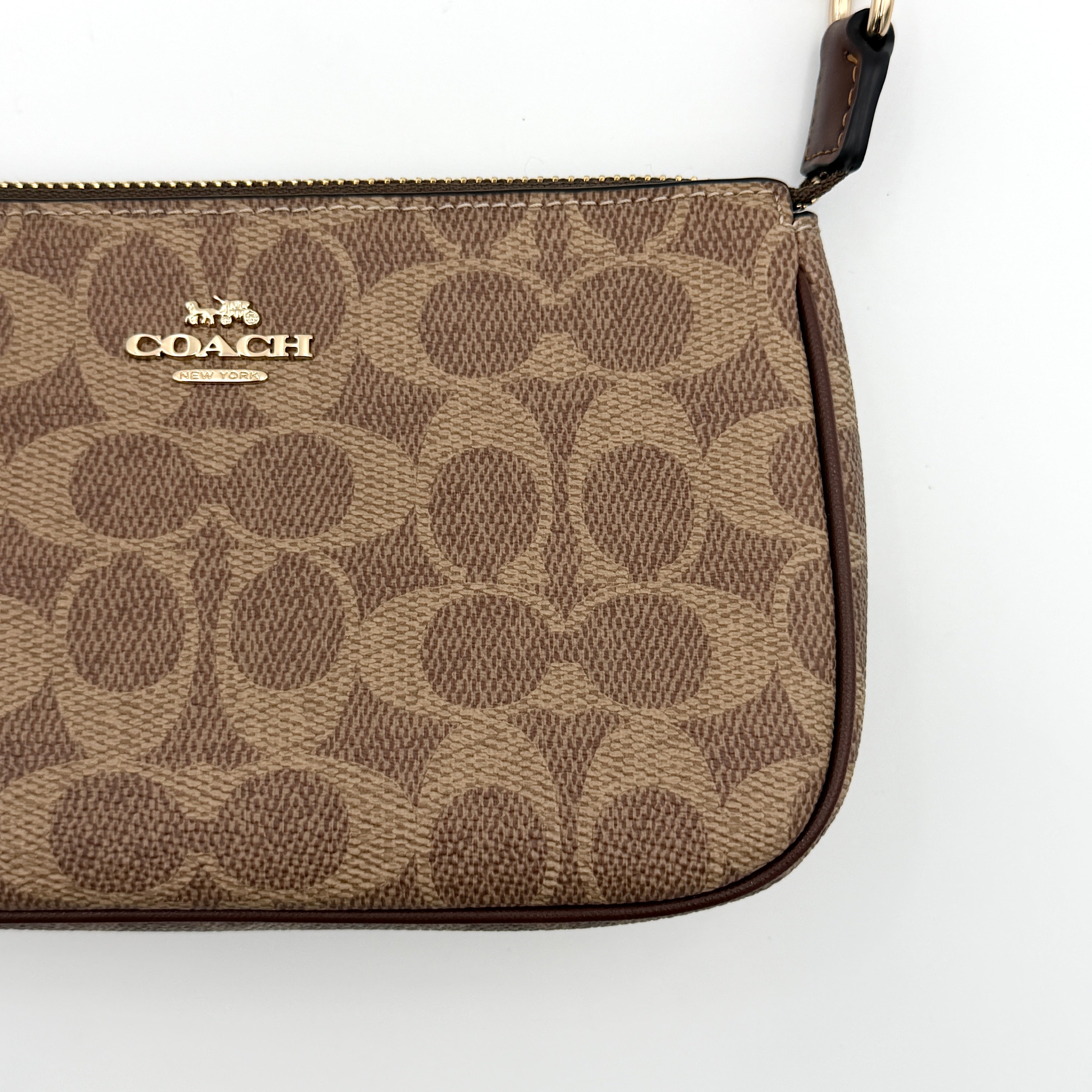Coach Signature Nolita 19 Shoulder Bag in beige and brown canvas with gold tone hardware and detachable leather strap.