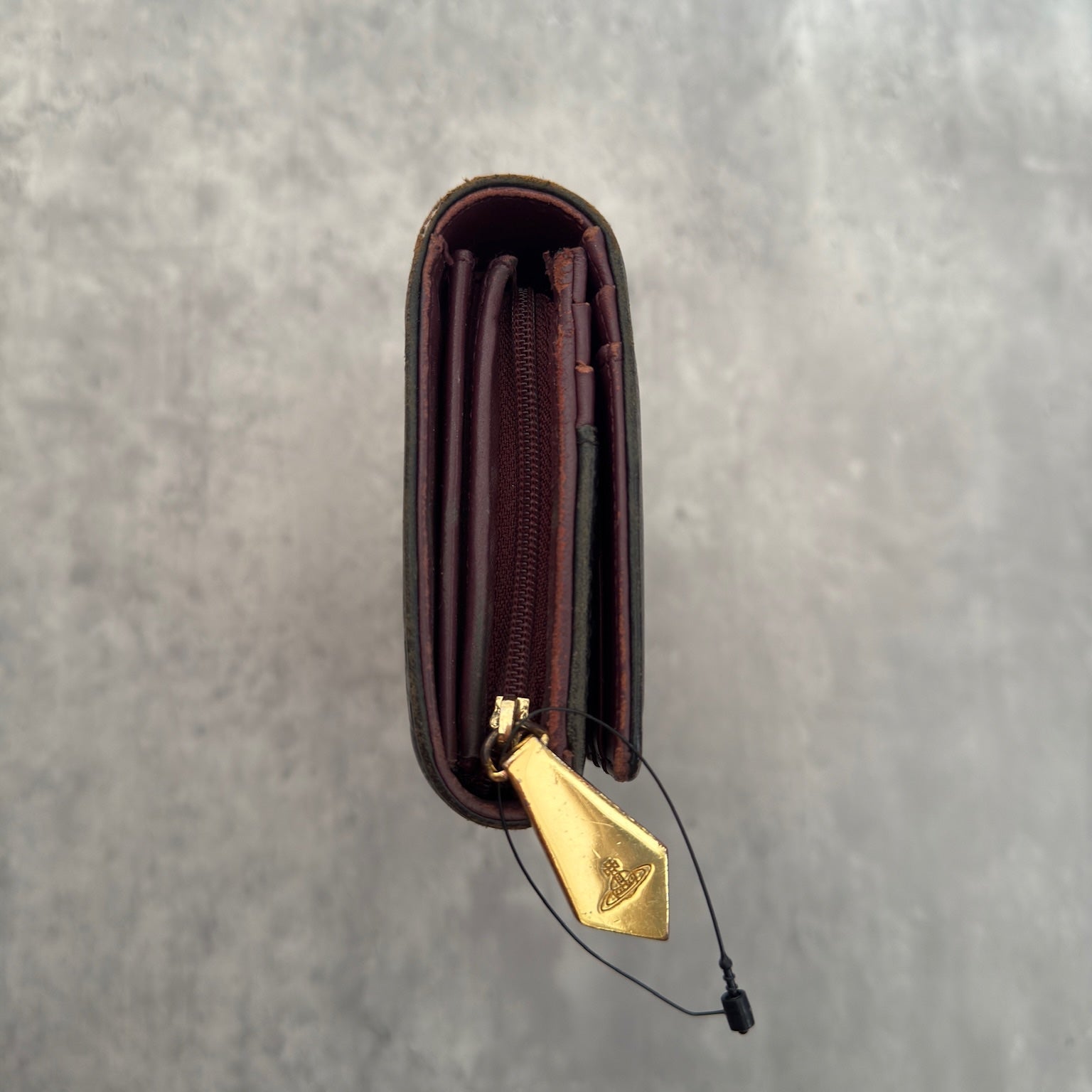 Vivienne Westwood Dancing Orb long wallet in black with iconic orb embossing, featuring a structured interior and clip closure, represents bold, punk-inspired luxury.