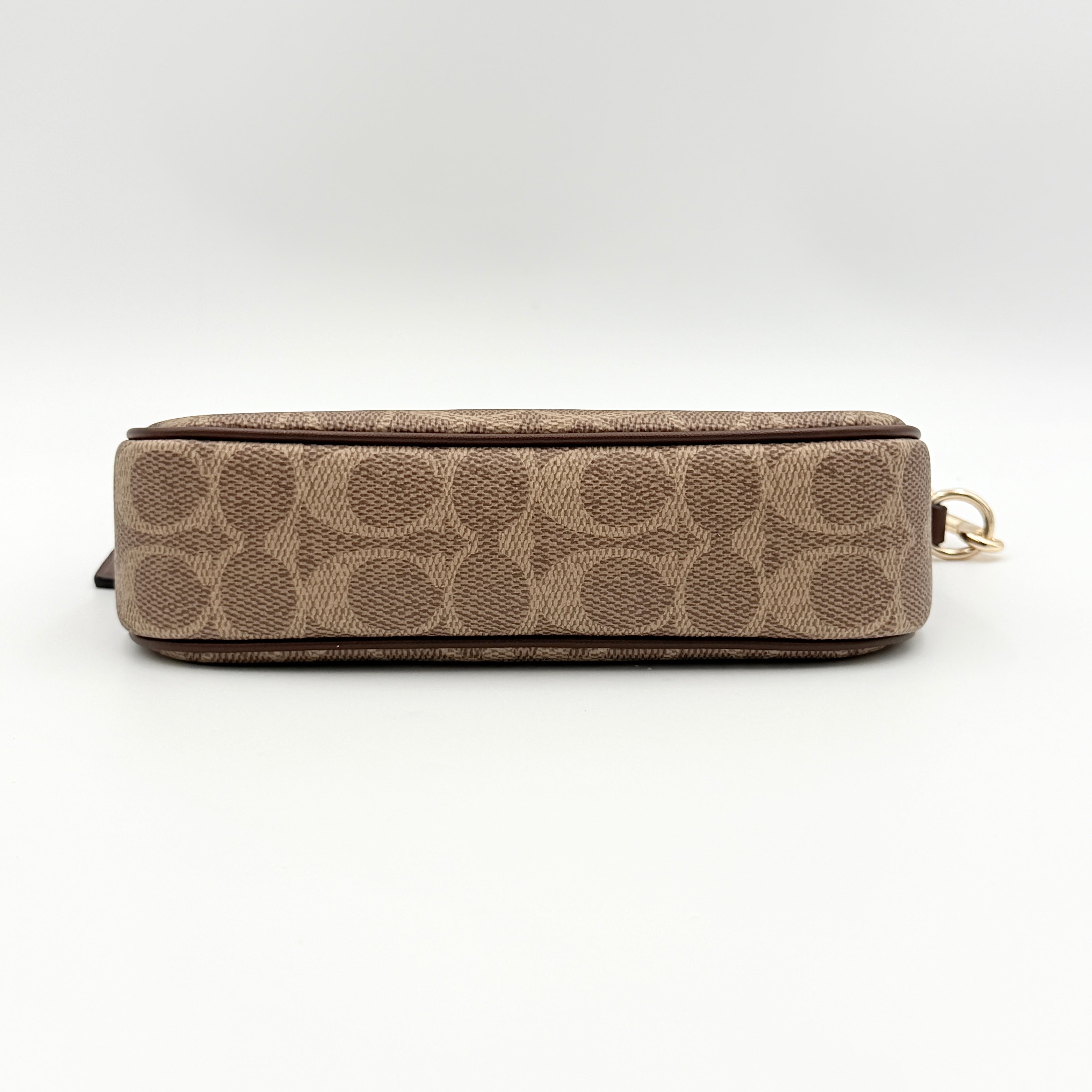 Coach Signature Nolita 19 Shoulder Bag in beige and brown canvas with gold tone hardware and detachable leather strap.
