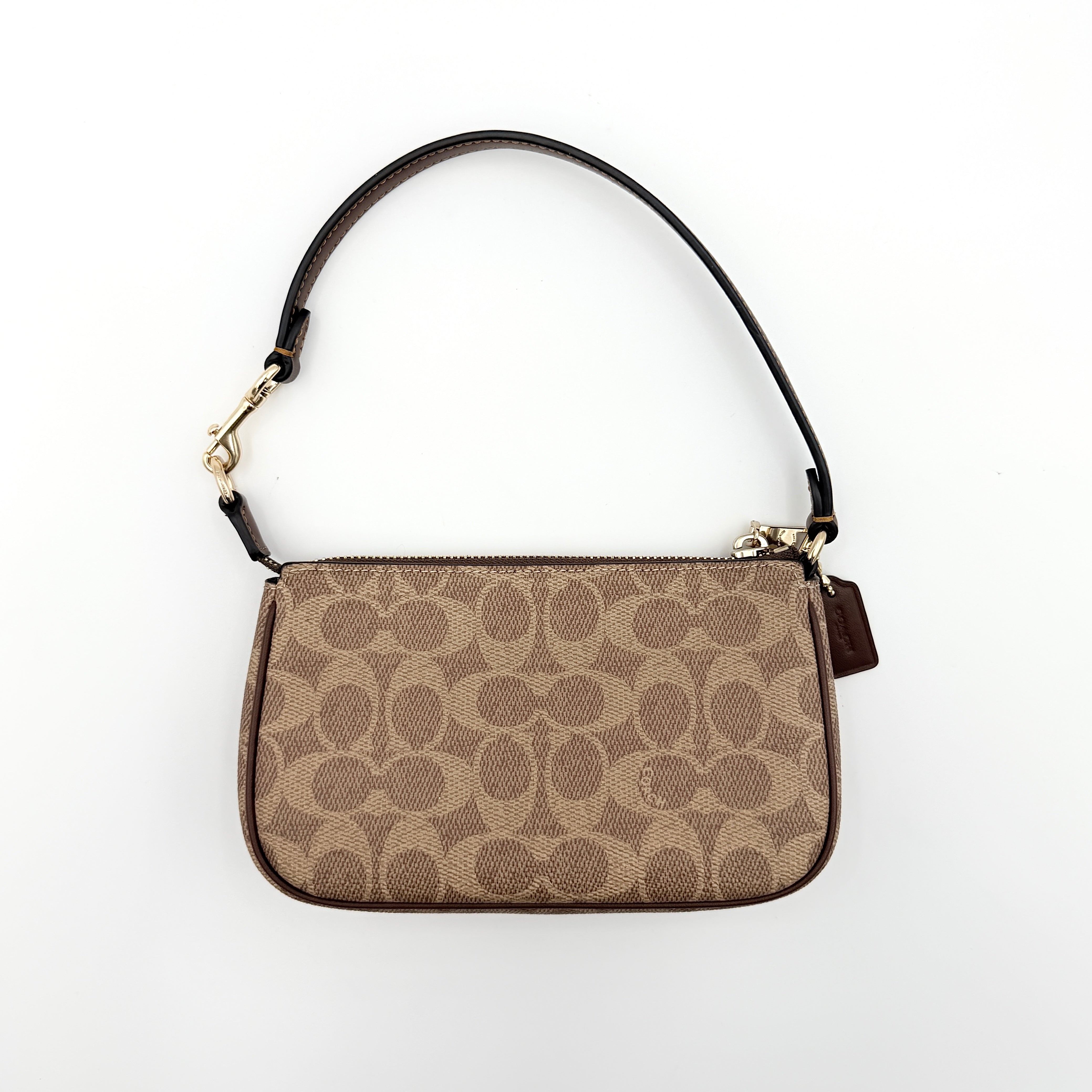Coach Signature Nolita 19 Shoulder Bag in beige and brown canvas with gold tone hardware and detachable leather strap.