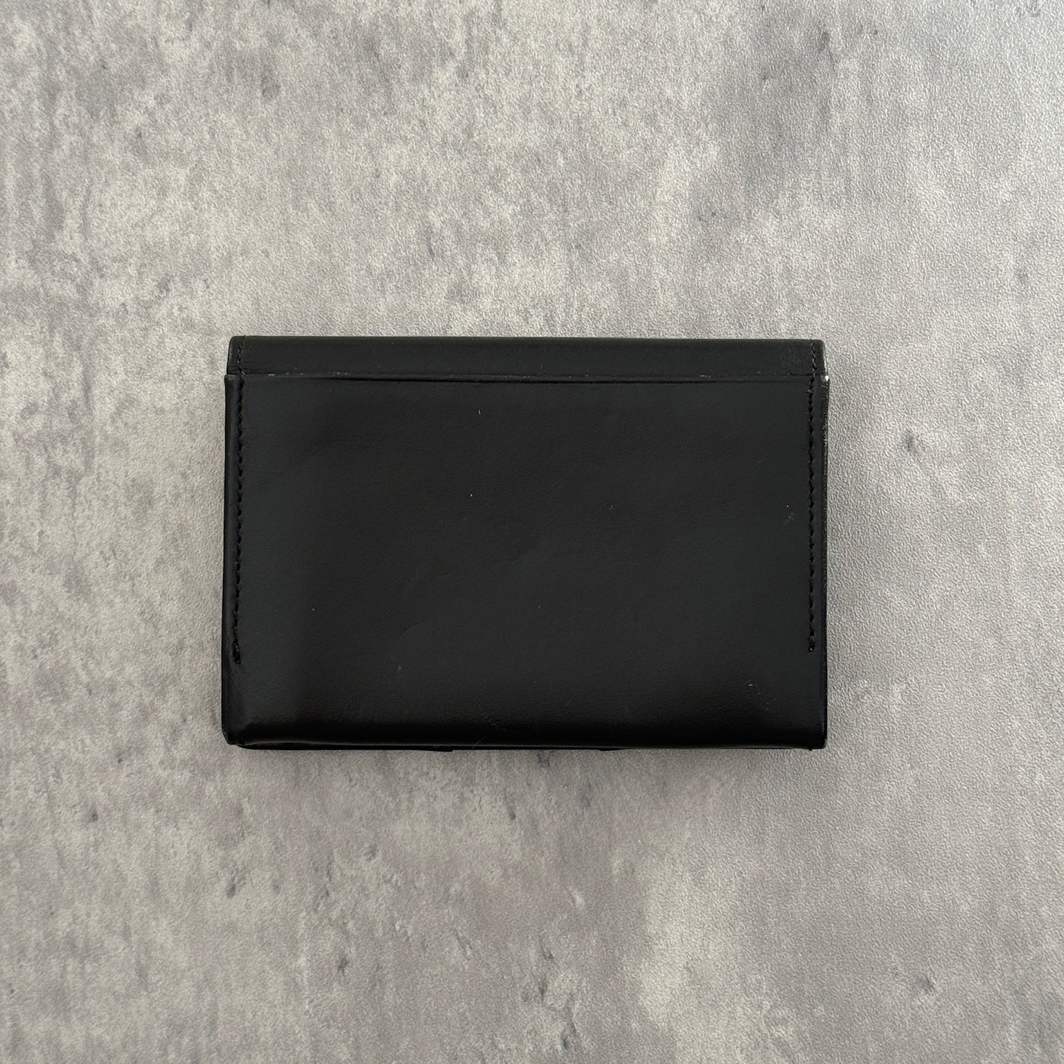 Black Vivienne Westwood cardholder with iconic silver Orb emblem, featuring multiple card slots and a central compartment, perfect for stylish organization.