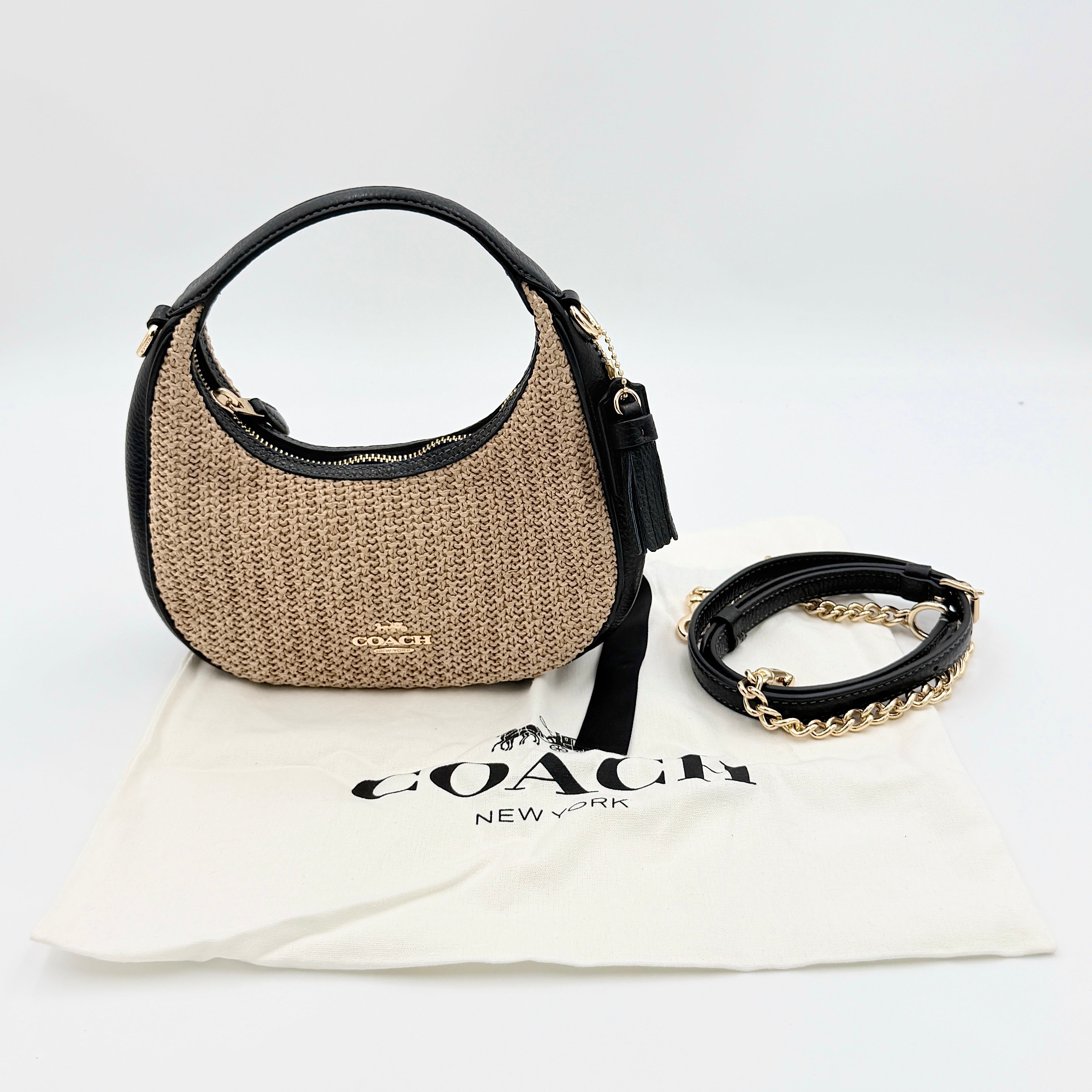 Coach Carmen Mini 2Way Shoulder Bag in beige and black with textured woven body, leather trim, and gold-tone hardware.