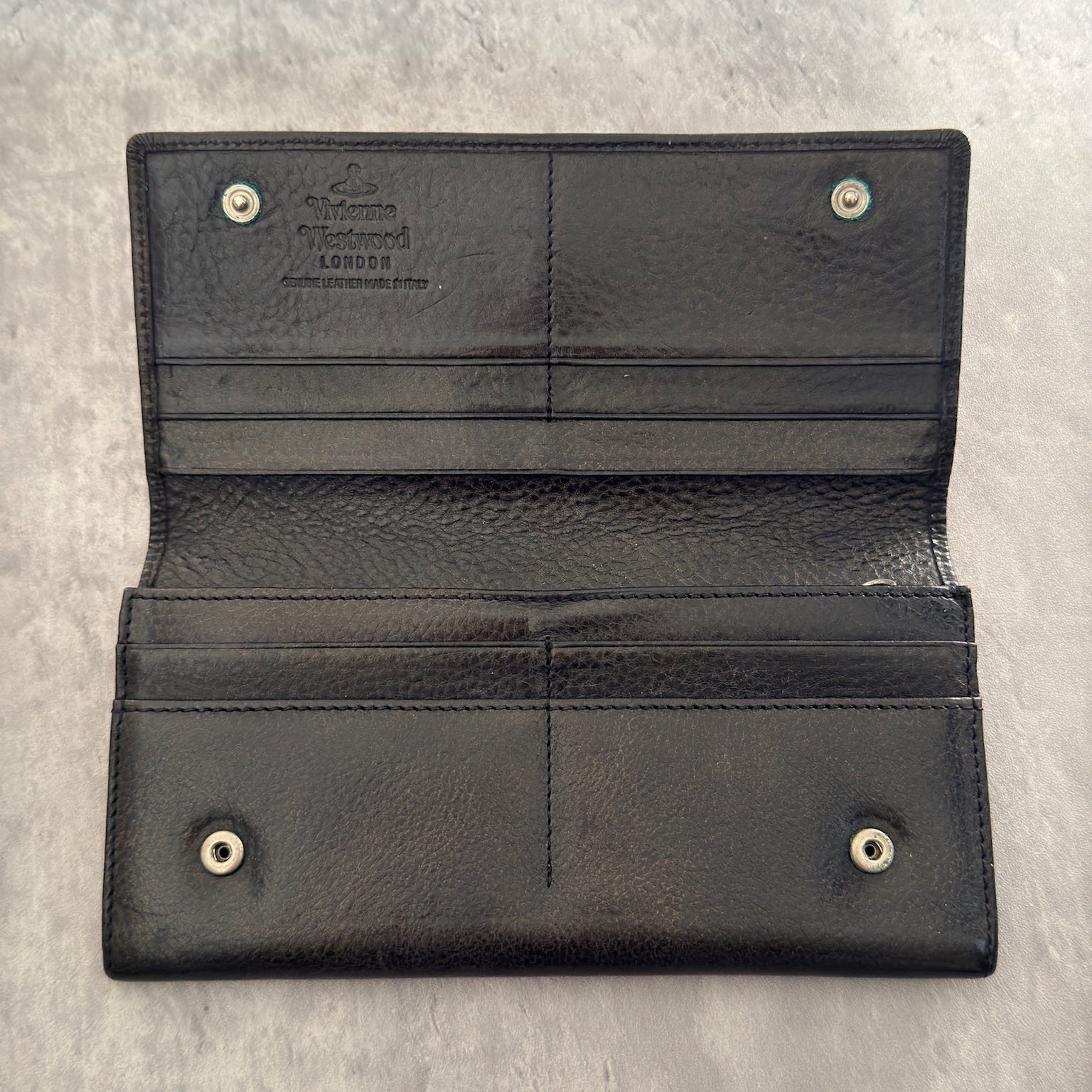 Vivienne Westwood Icon Signature Long Wallet in black leather, featuring logo plaque, multiple card slots and zip compartment interior, snap button closure, vintage condition.