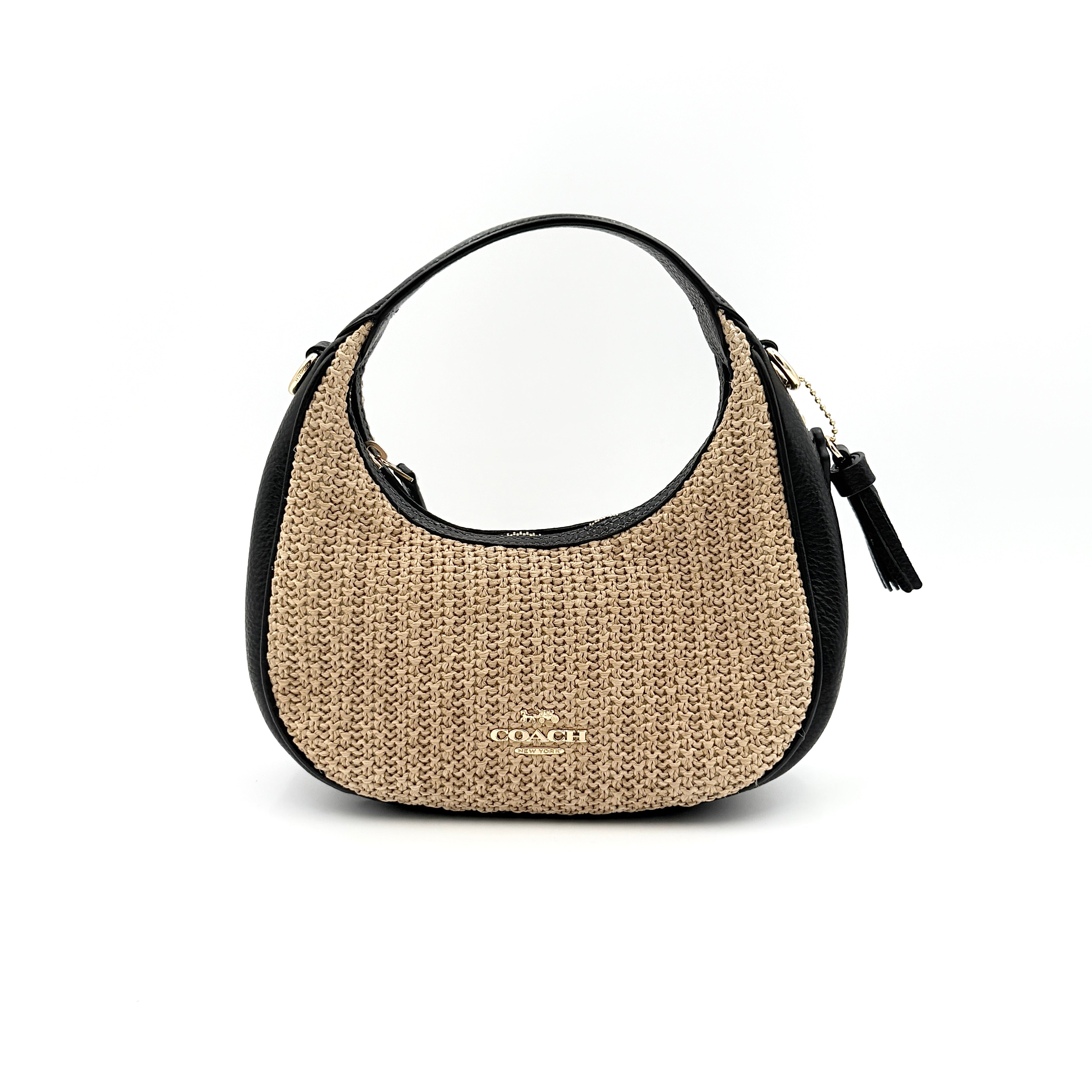 Coach Carmen Mini 2Way Shoulder Bag in beige and black with textured woven body, leather trim, and gold-tone hardware.
