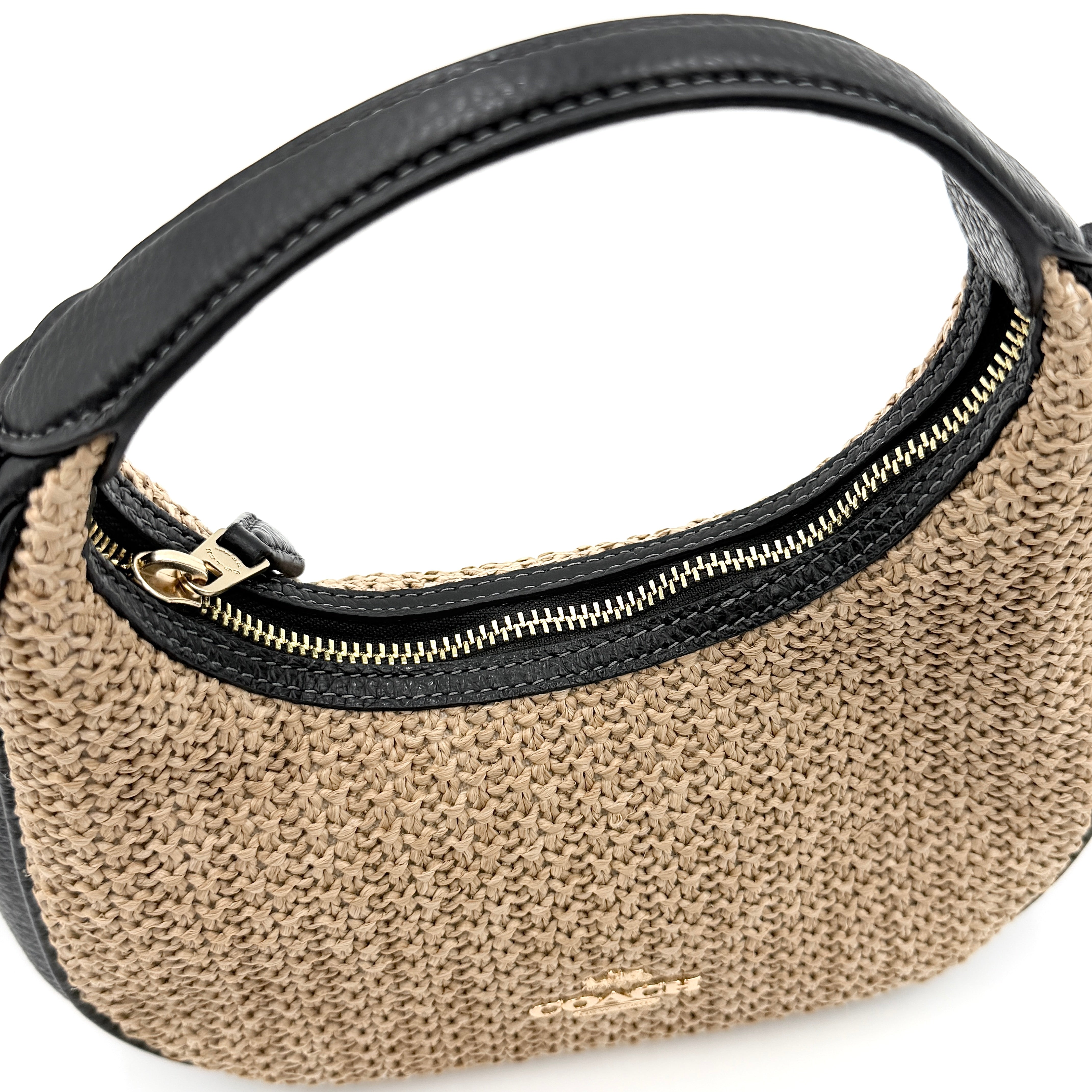 Coach Carmen Mini 2Way Shoulder Bag in beige and black with textured woven body, leather trim, and gold-tone hardware.