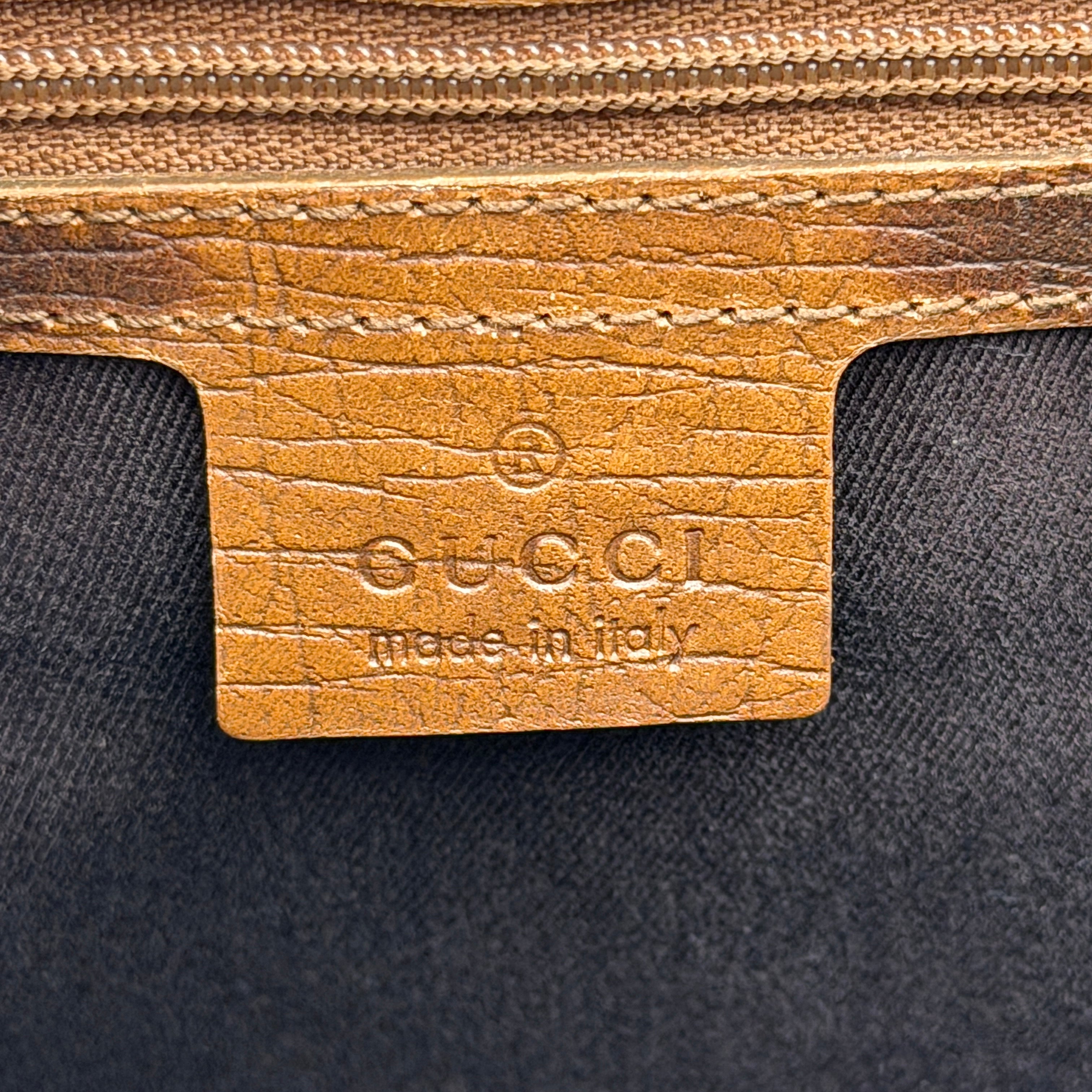 Gucci GG Monogram Bamboo Shoulder Bag in beige and brown canvas with bamboo top handles displayed upright.