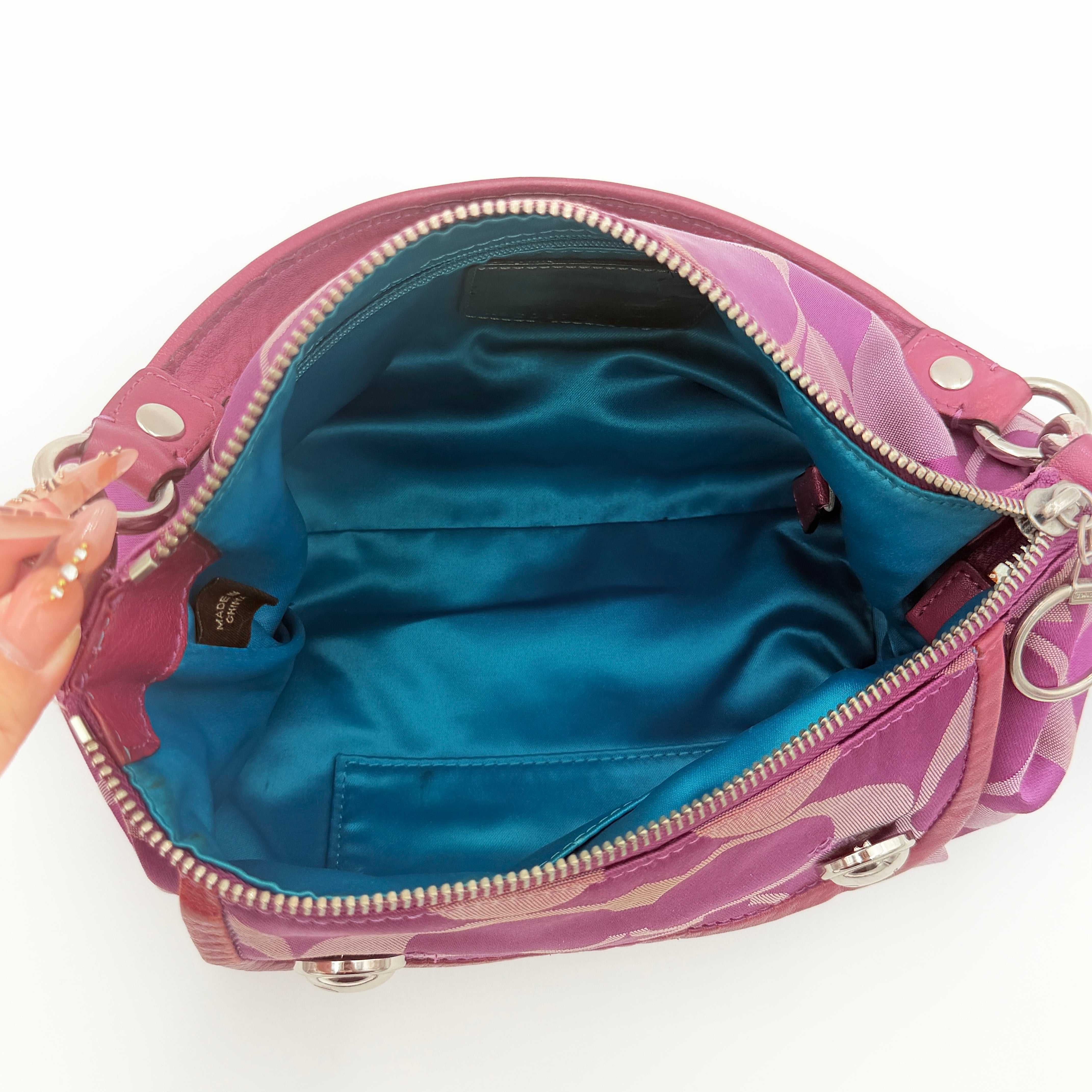 Coach 2Way Signature Shoulder Bag in purple canvas with detachable strap and top handle.
