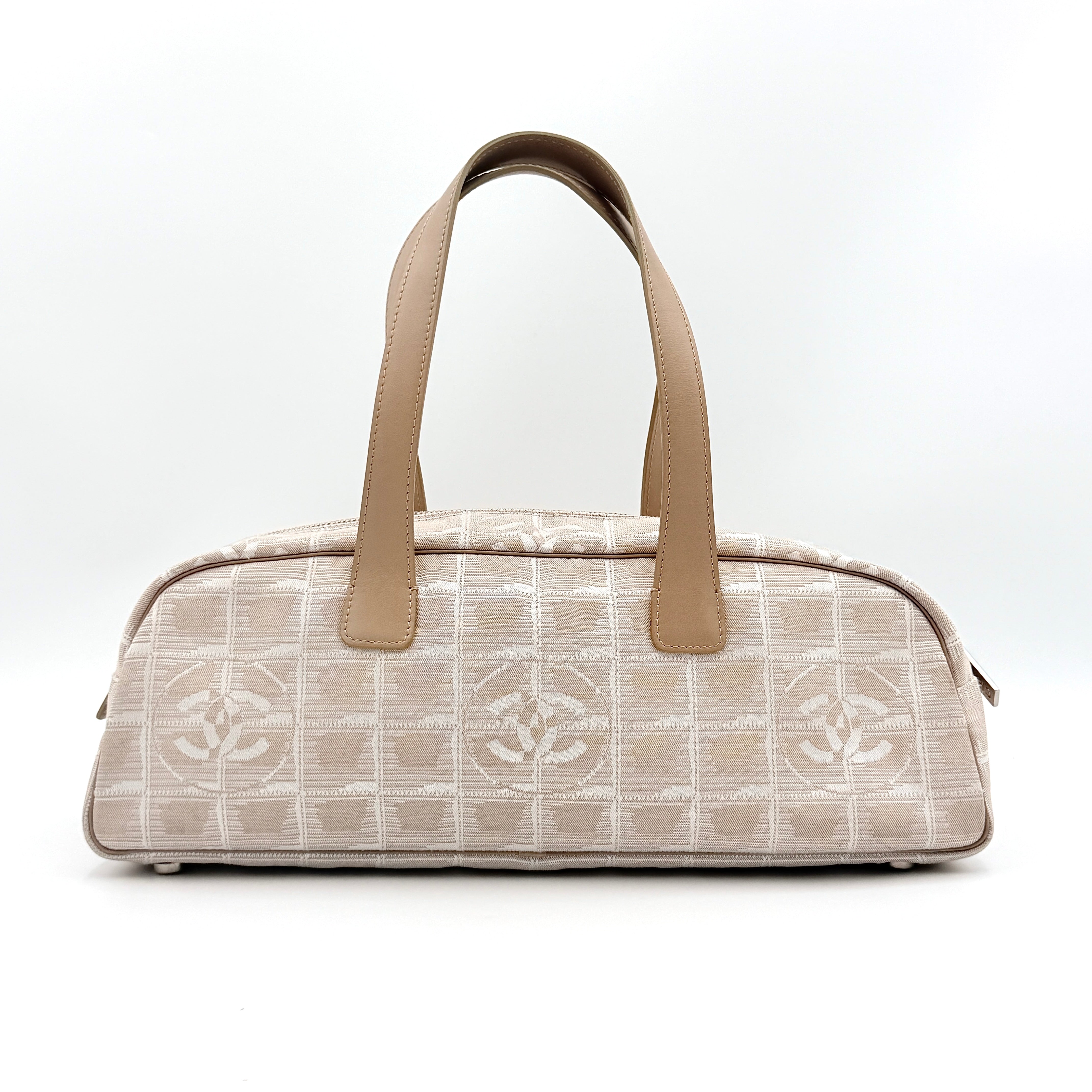 Chanel Travel Mini Boston Bag in beige nylon with CC motif and tan leather handles, shown in front view.