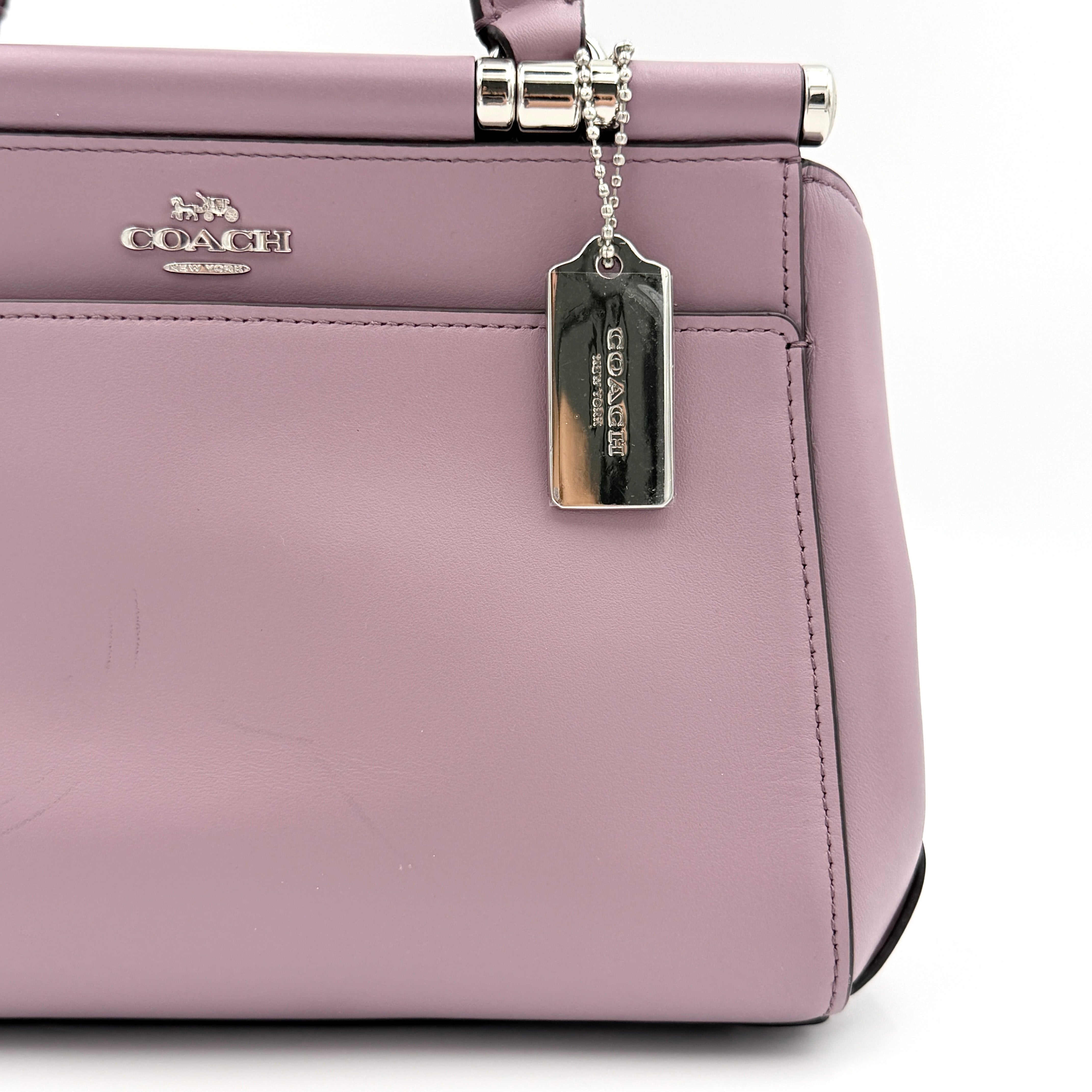 Coach Grace 20 bag in pink leather with silver hardware, shown with its detachable strap.