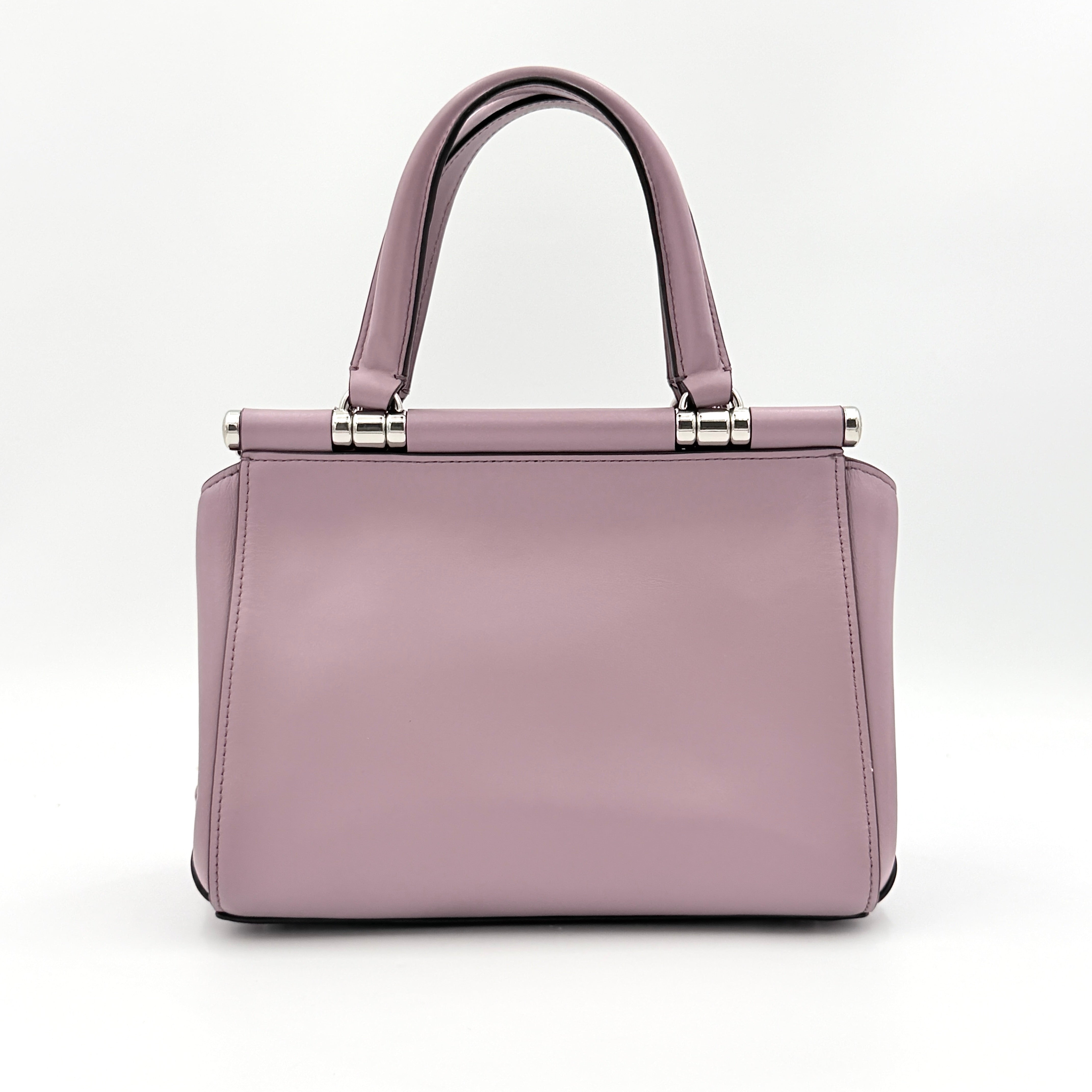 Coach Grace 20 bag in pink leather with silver hardware, shown with its detachable strap.