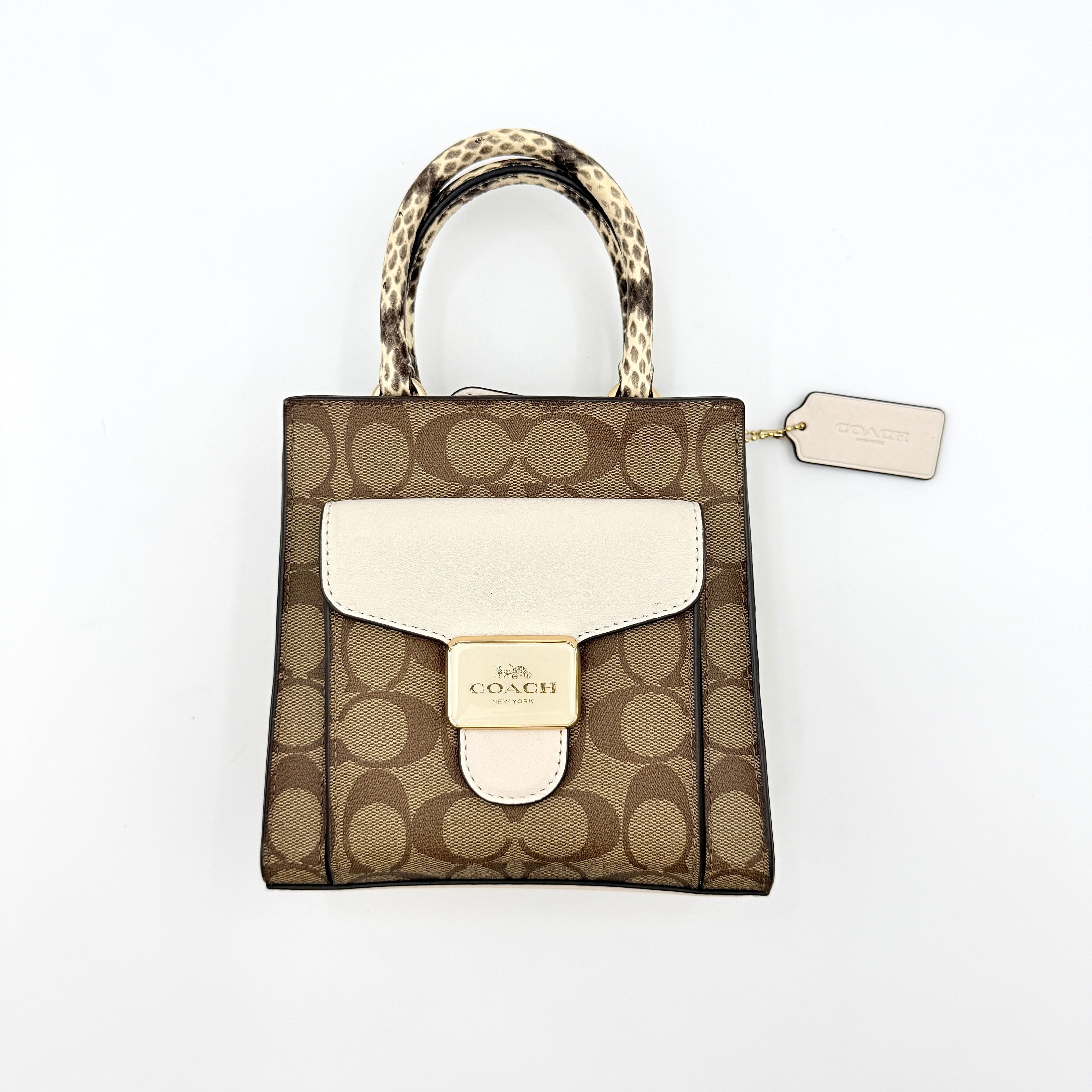 Coach Mini Pepper HandBag in beige canvas with white leather and snakeskin-effect handle, styled with detachable crossbody strap.