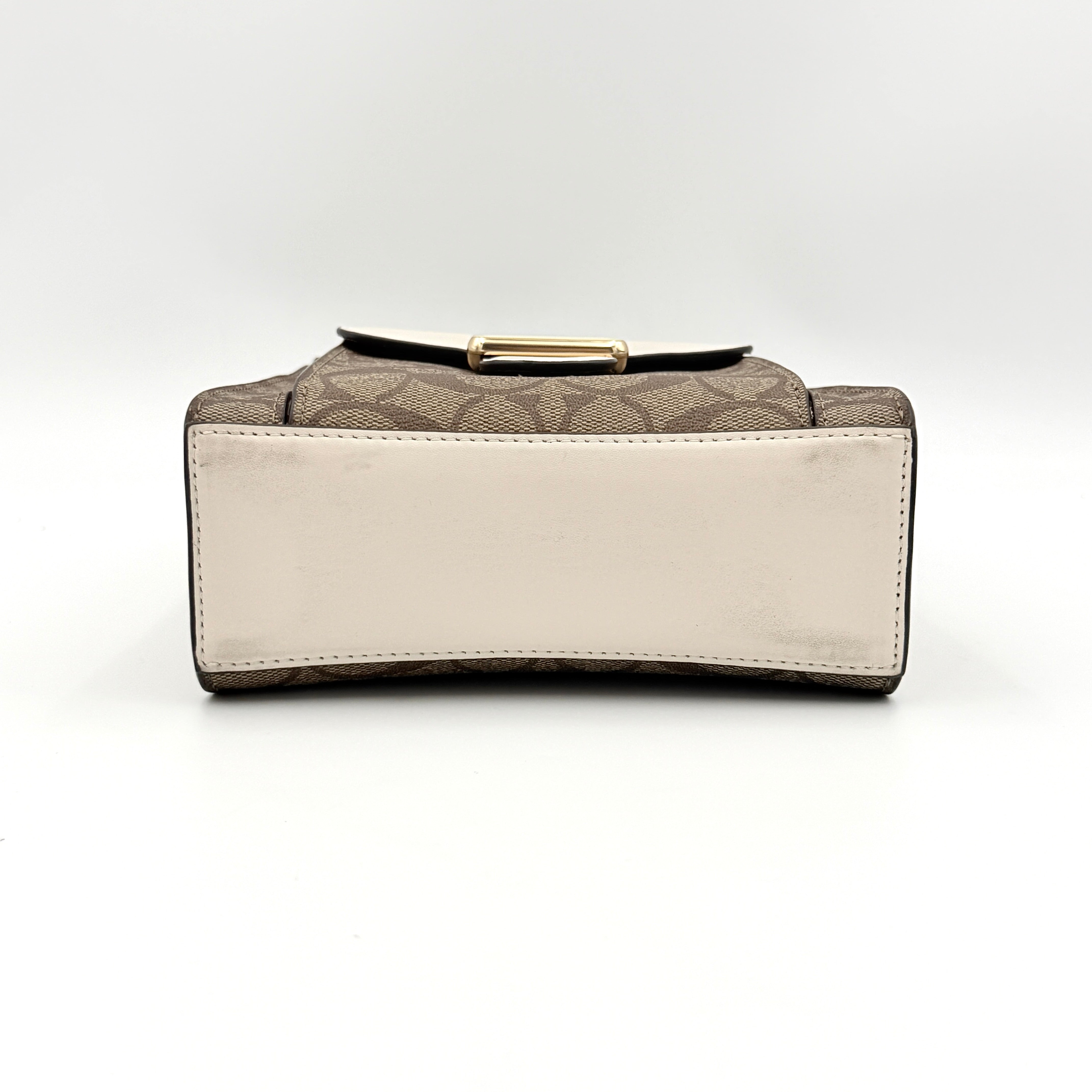 Coach Mini Pepper HandBag in beige canvas with white leather and snakeskin-effect handle, styled with detachable crossbody strap.