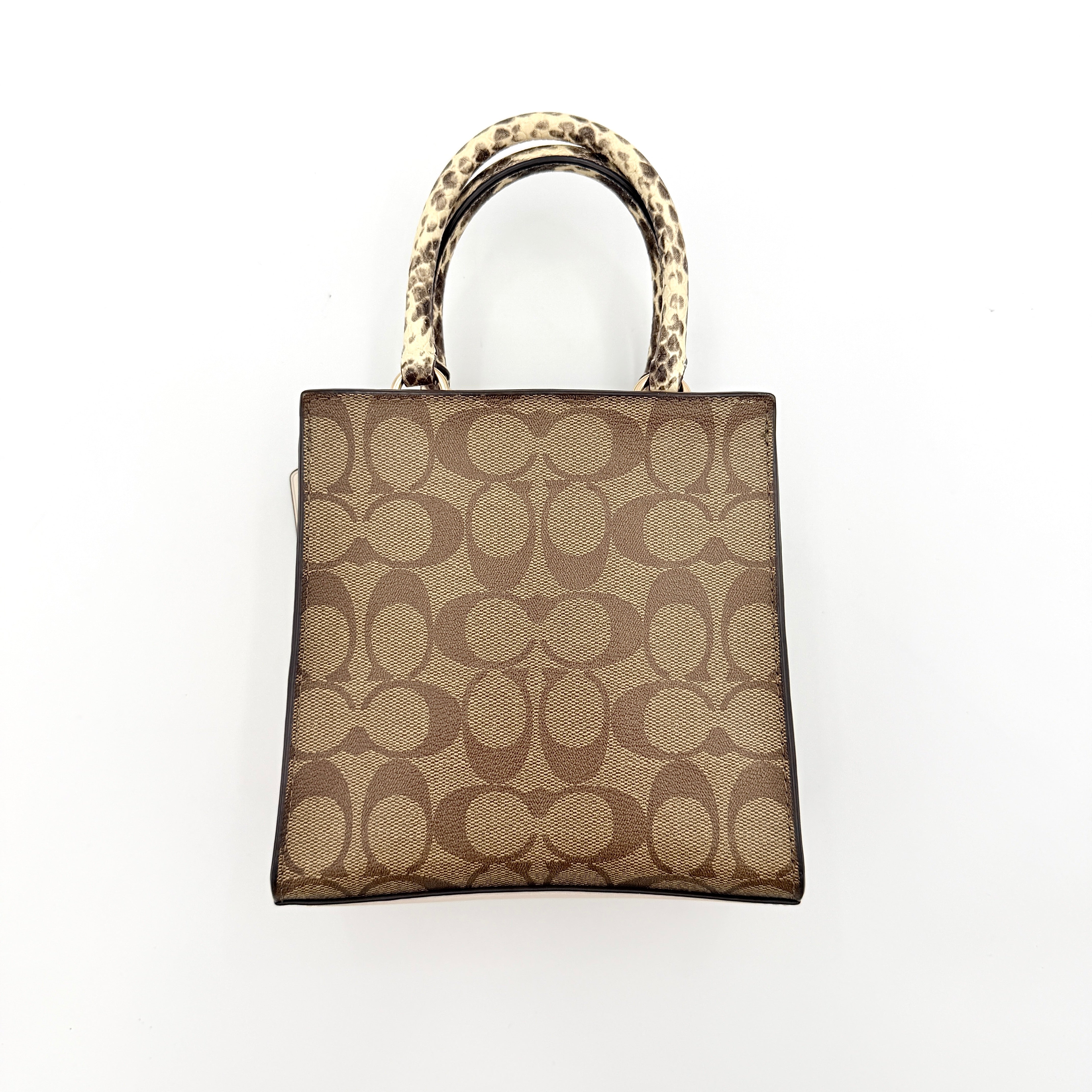Coach Mini Pepper HandBag in beige canvas with white leather and snakeskin-effect handle, styled with detachable crossbody strap.