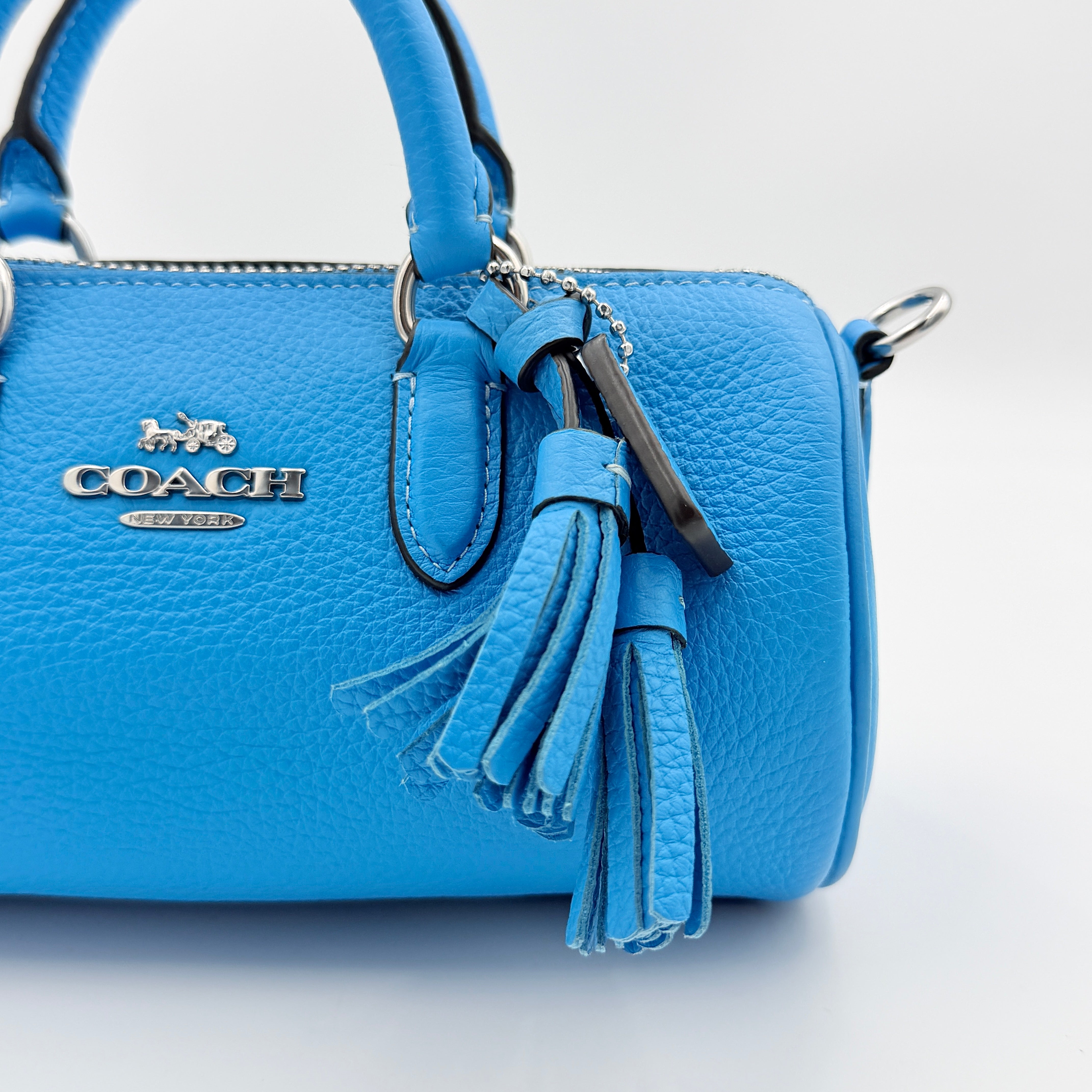 Coach 2Way Lacey Mini Boston Bag in blue pebbled leather with silver hardware and detachable strap, displayed against a clean background.