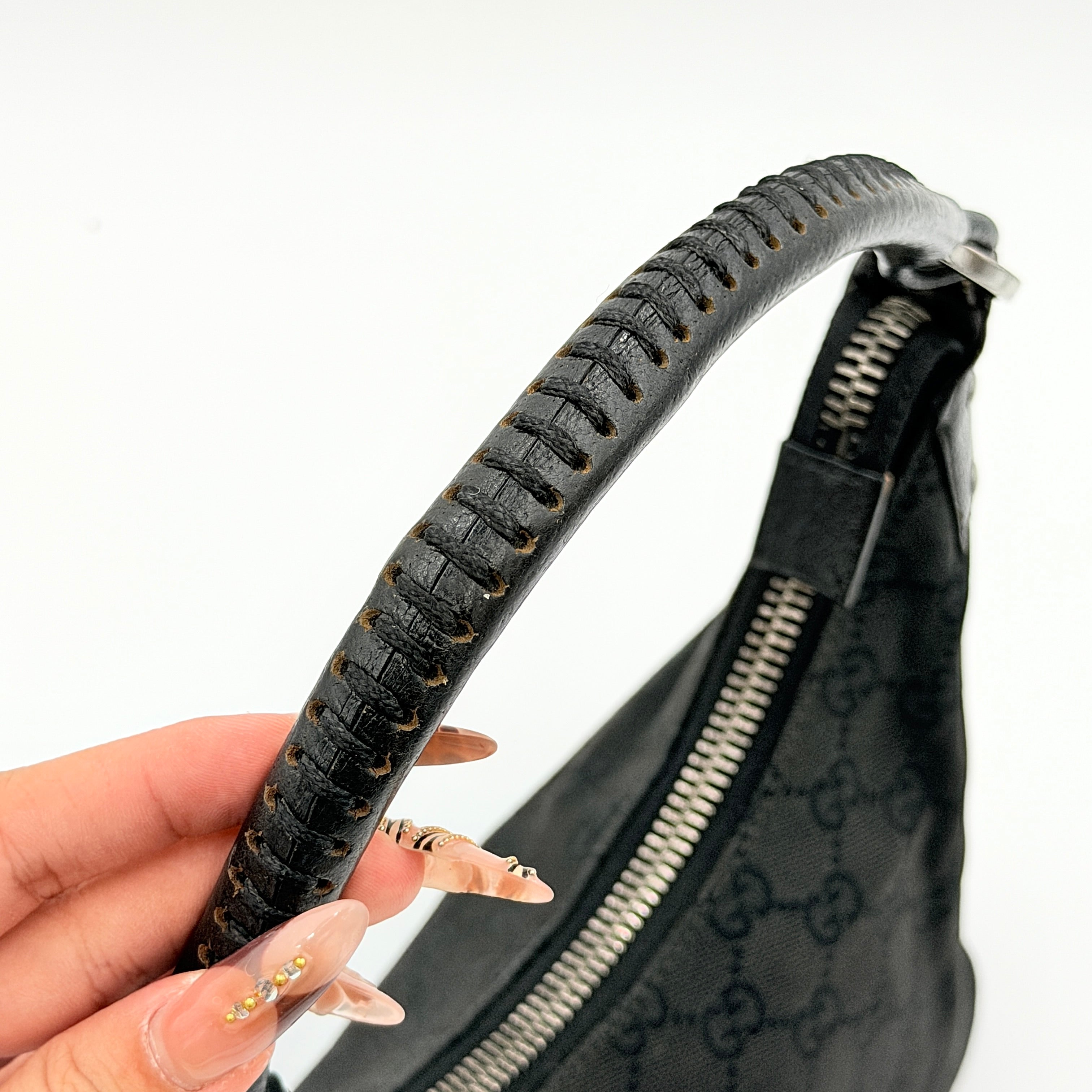 Gucci GG Monogram Lock Hobo Shoulder Bag in black jacquard canvas with leather trim and silver-tone hardware, shown on a white background.