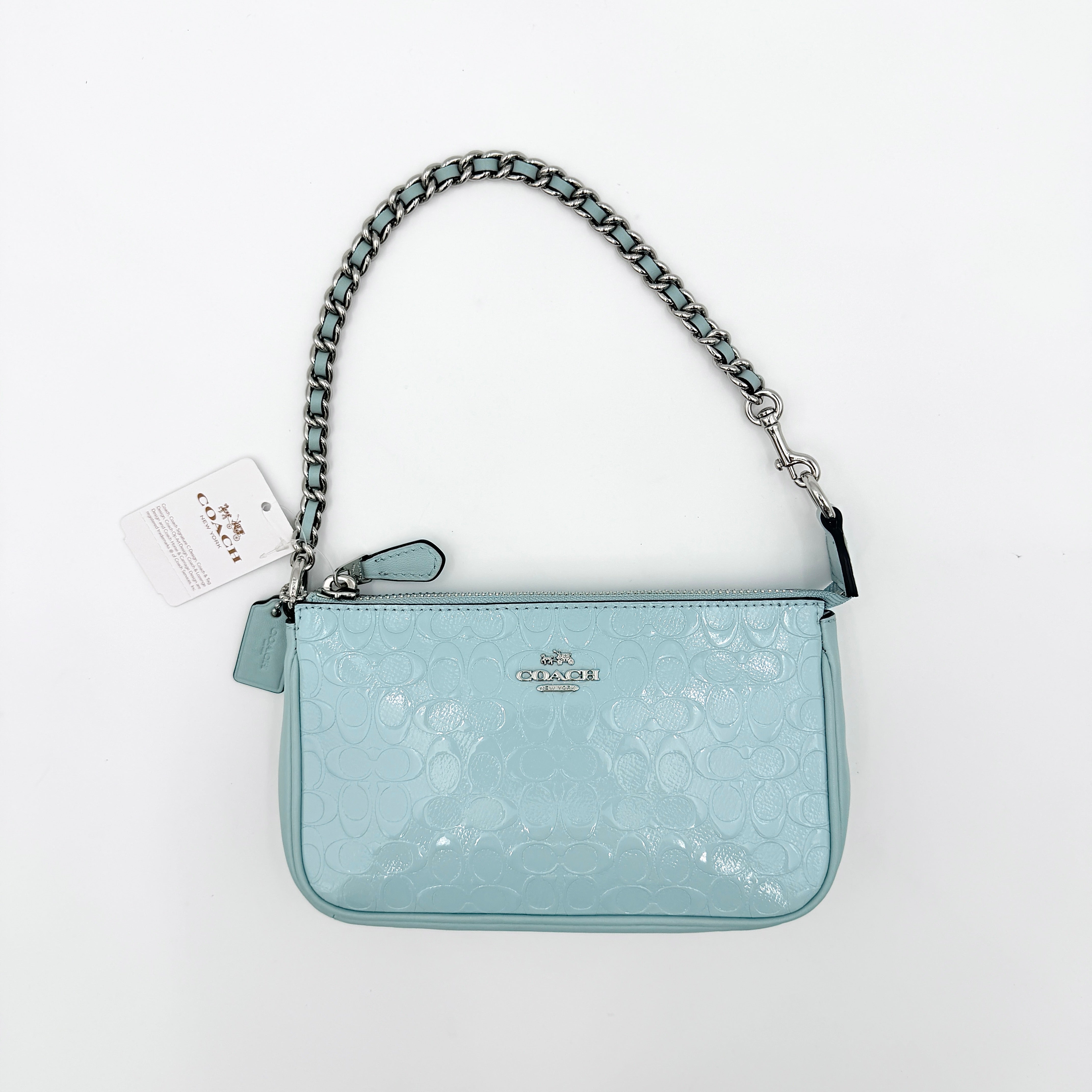 Coach Nolita 19 small shoulder bag in light blue embossed patent leather with silver-tone chain strap shown against a white background.