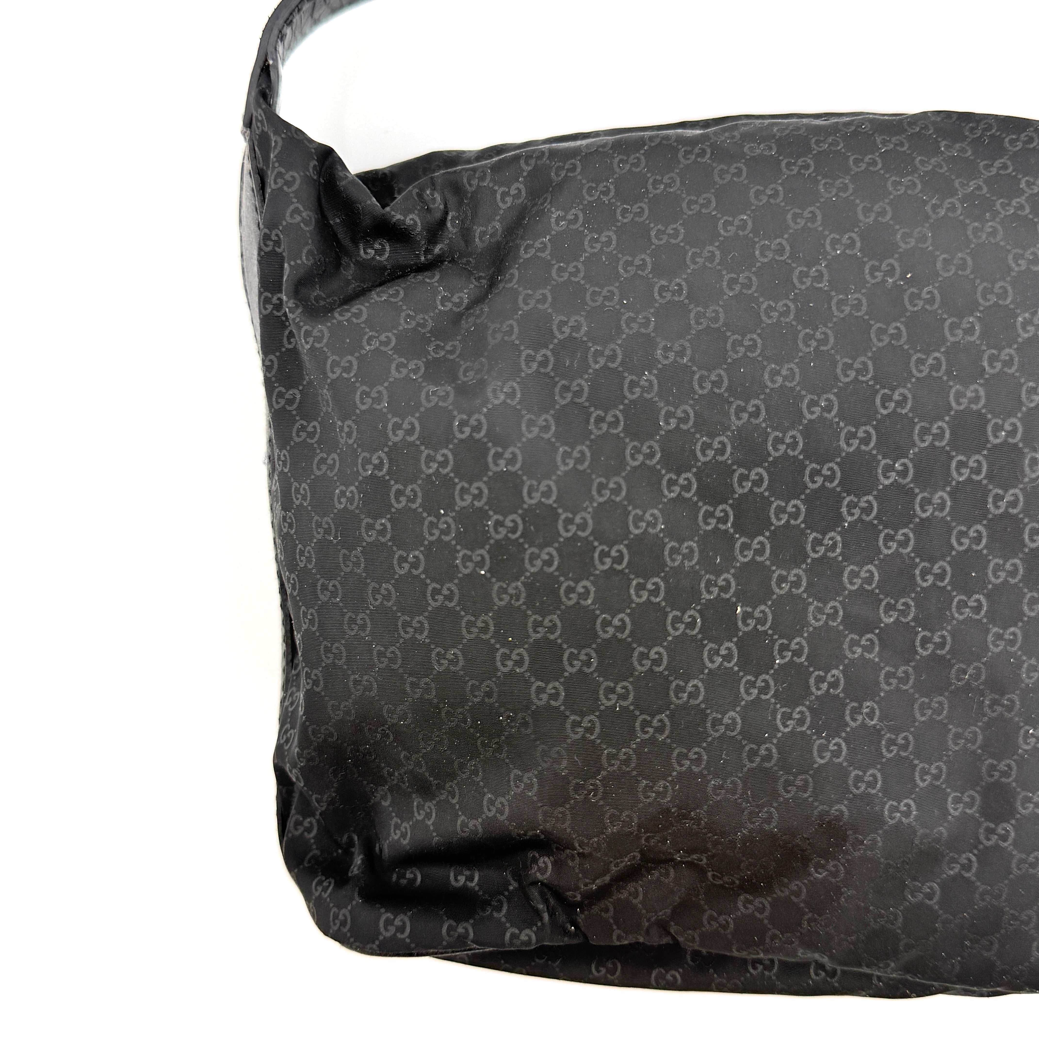 Gucci GG Monogram Mini Hobo black nylon shoulder bag with leather trim and silver-tone hardware, displayed on a plain background.